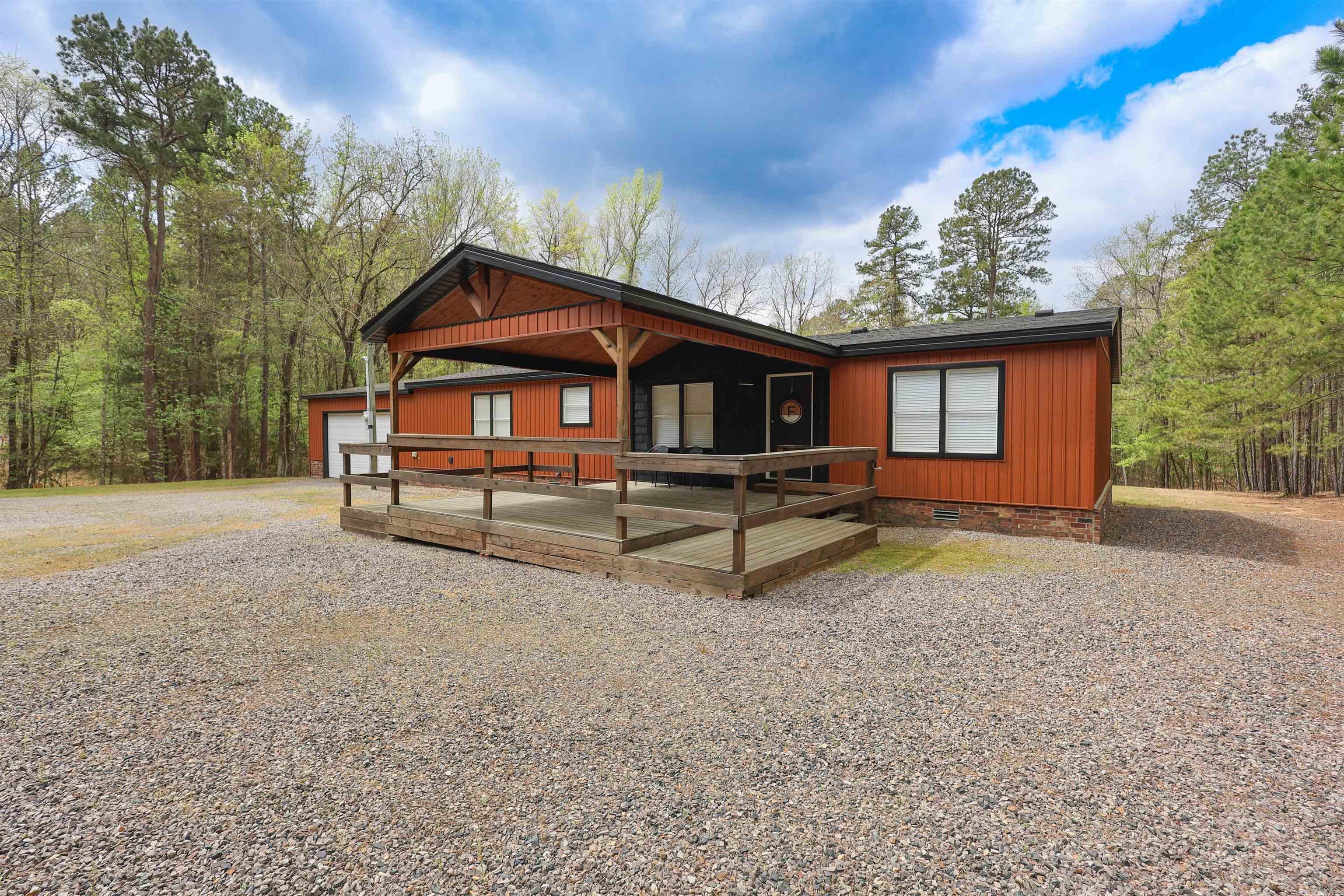 Located just 2 miles from the Twin Creek Recreation Area and Ouachita Shores and  approximately 30 miles from Hot Springs, this 3-bedroom, 2-bath fully furnished mobile home offers the perfect blend of comfort and convenience near Lake Ouachita. Whether you're looking for a full-time residence, weekend getaway, or investment opportunity, this property is move-in ready and ideally situated for enjoying the outdoors.  The home features granite countertops, updated appliances (approx. 4 years old), and a smart thermostat for modern efficiency. Recent improvements include a new HVAC system (installed approx. 1 year ago), durable vinyl blended siding (also approx. 1 year old), and a roof replaced around 4 years ago. The property is serviced by both a well and city water, offering flexibility and reliability.  Outdoor living is a standout with a spacious 16x20 front wood deck and a 24x12 back deck—perfect for relaxing or entertaining. Additional features include 50-amp service at the front of the home, making it ideal for RV use or additional setup. With its combination of updates, furnishings, and proximity to recreation, this property is ready to enjoy from day one.