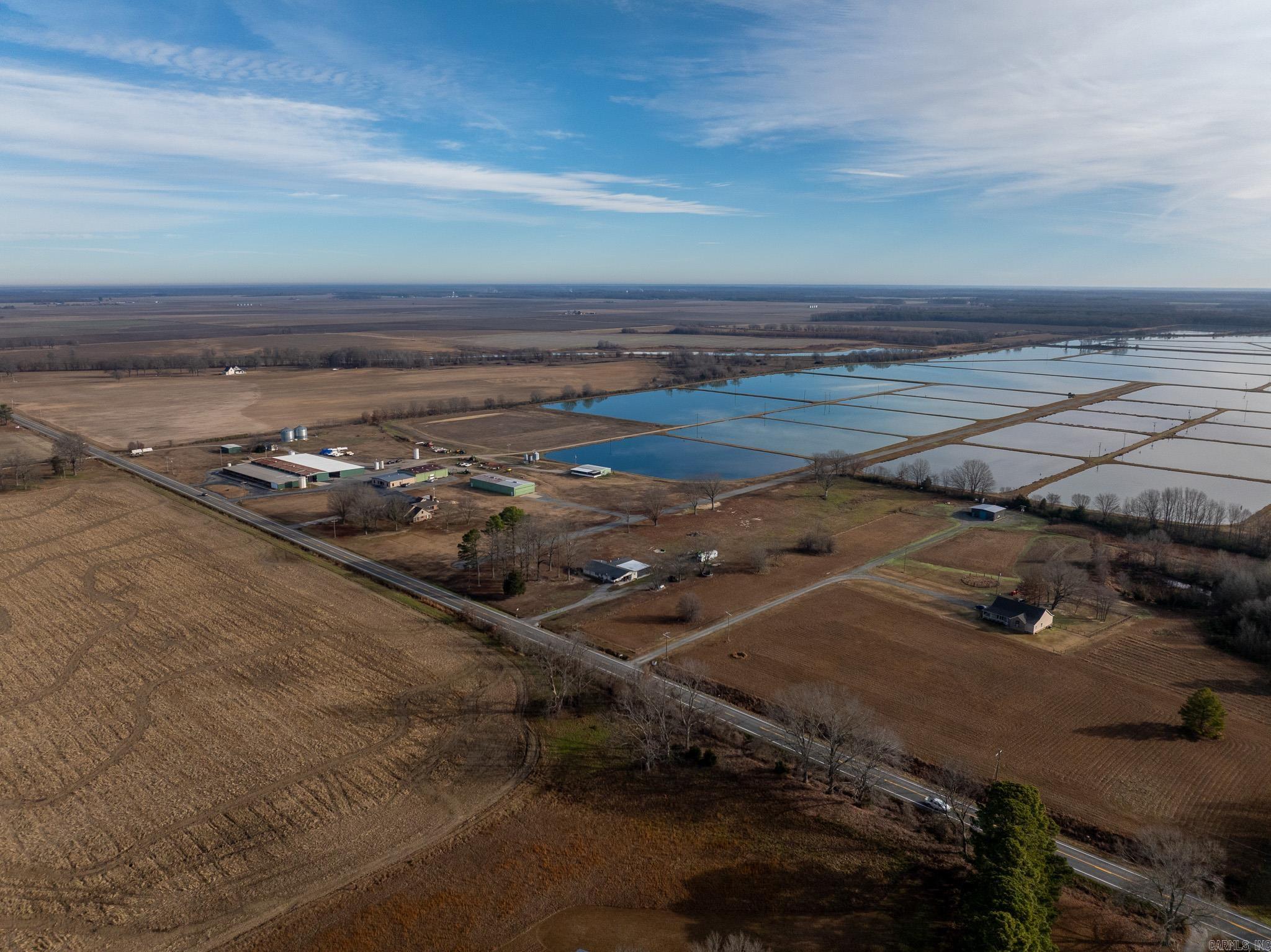 Prairie County Legacy Farms is a turn-key, income-producing operation with established revenue streams and experienced personnel. Located in a premier agricultural and industrial corridor of Prairie County, Arkansas, the 1,146± acre property fronts Highway 11 and is less than 8 miles from Interstate 40, offering rapid access to Little Rock (30 min) and Memphis (1.5 hrs) — ideal for agribusiness, industrial manufacturers, logistics operations, or data center development.  The property supports row-crop production, aquaculture, and recreational waterfowl hunting, with a proven rotation of rice, edamame, soybeans, and corn, plus extensive irrigation infrastructure, water management systems, and energy-efficient improvements — providing a strong foundation for renewable energy integration, including solar, agrivoltaics, or other clean energy projects. Improvements include a fully developed headquarters, offices, shops, grain storage, worker housing, bunkhouse, and private airstrip. A seasoned workforce ensures continuity, positioning the farm for immediate operation, operational expansion, and diverse investment opportunities.