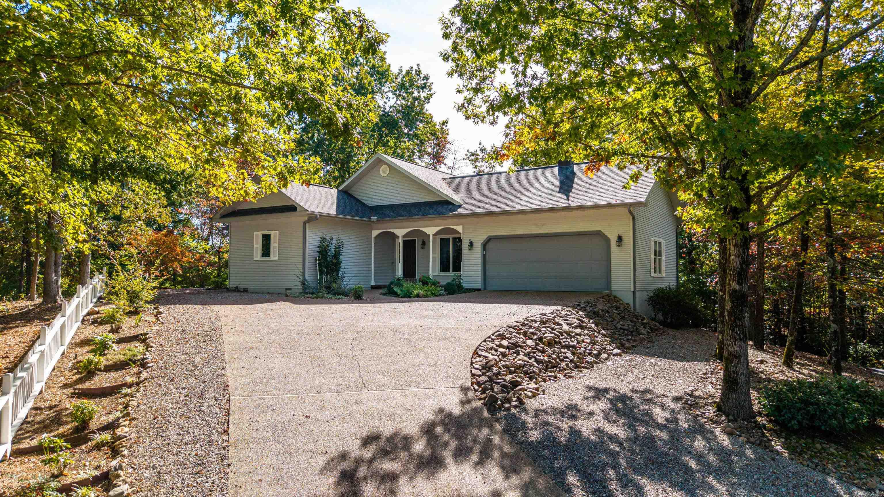 Beautifully crafted custom home in highly sought-after Lake Balboa area of Hot Springs Village, offering seasonal lake views from an elevated, private setting. Perched atop a hill, this home captures spacious views and a peaceful, tucked-away feel while remaining close to all village amenities. Built with an emphasis on quality, the interior showcases solid wood doors, rich wood trim, and a thoughtfully designed layout that supports both everyday living and entertaining. The main living area is separated from a dedicated office, optional dining space, or 3rd bedroom with minor modifications. The Arkansas Room provides a versatile second living area with UV-tinted windows for comfort and energy efficiency.This 2 bedroom home with a designated office offers flexibility for full-time living or a retreat. The oversized garage (approx. 600 sq ft) easily accommodates vehicles, a golf cart, or workshop space. Brand new roof 2026. Located near Lake Balboa marina, enjoy access to 11 lakes, 9 golf courses, walking trails, tennis, pickleball, dining, medical, and more. Experience the charm, privacy, and craftsmanship making this home stand out—this is Hot Springs Village living at its finest.