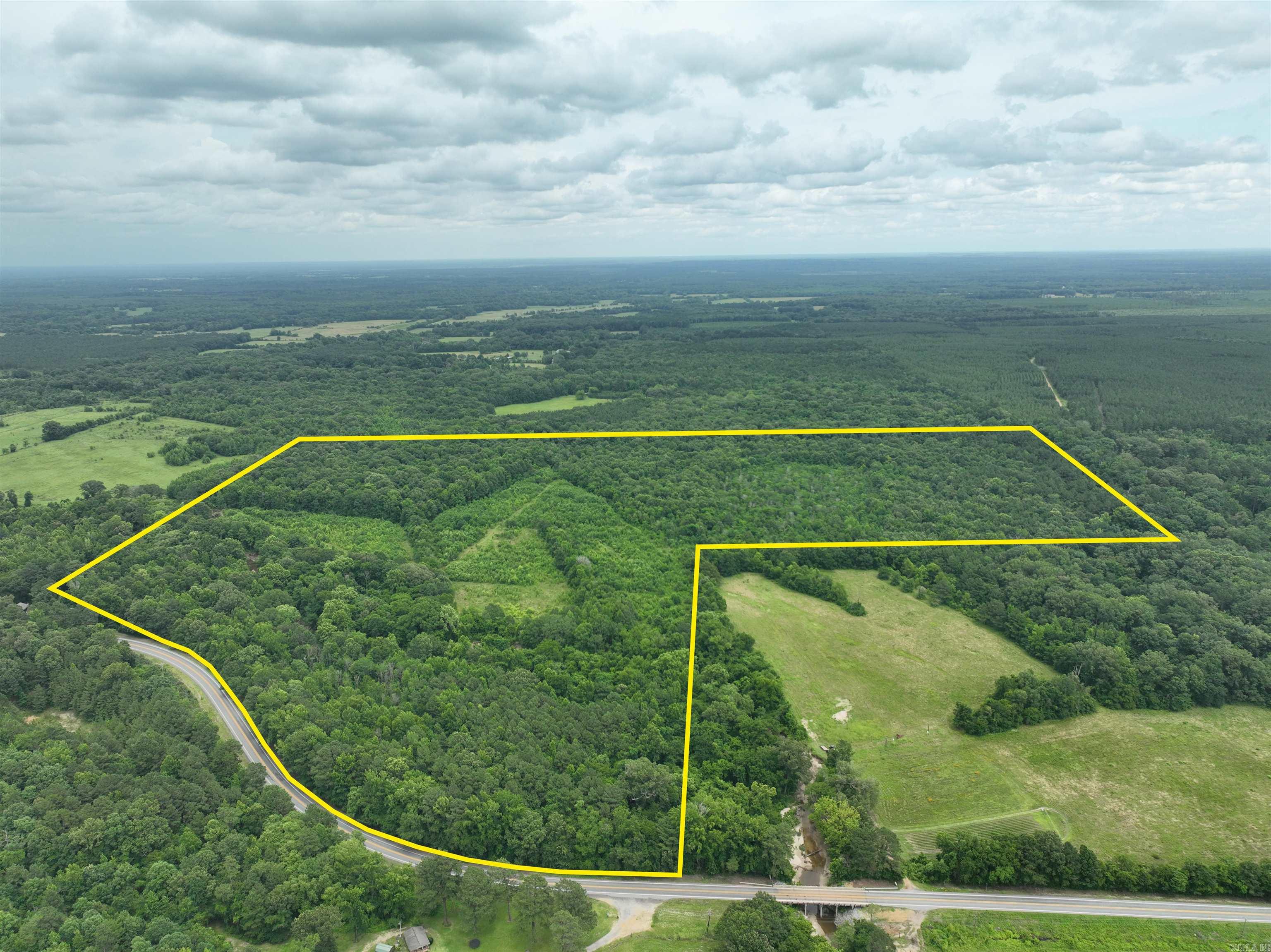 Located in Clark County with direct frontage on Highway 53, this 118-acre property offers a well-rounded mix of timber and naturally regenerated pasture. The South Fork Terre Noire Creek meanders through the land, providing a year-round water source and enhancing its appeal as a wildlife haven. Natural game funnels and multiple food plot locations make it an excellent choice for hunting deer, turkey, and other game species.  Beyond its recreational value, the open areas on the property could be reclaimed for hay production or livestock grazing. Whether you’re looking for a secluded hunting tract, or a productive piece of rural ground, this property offers flexibility, access, and natural beauty all in one.