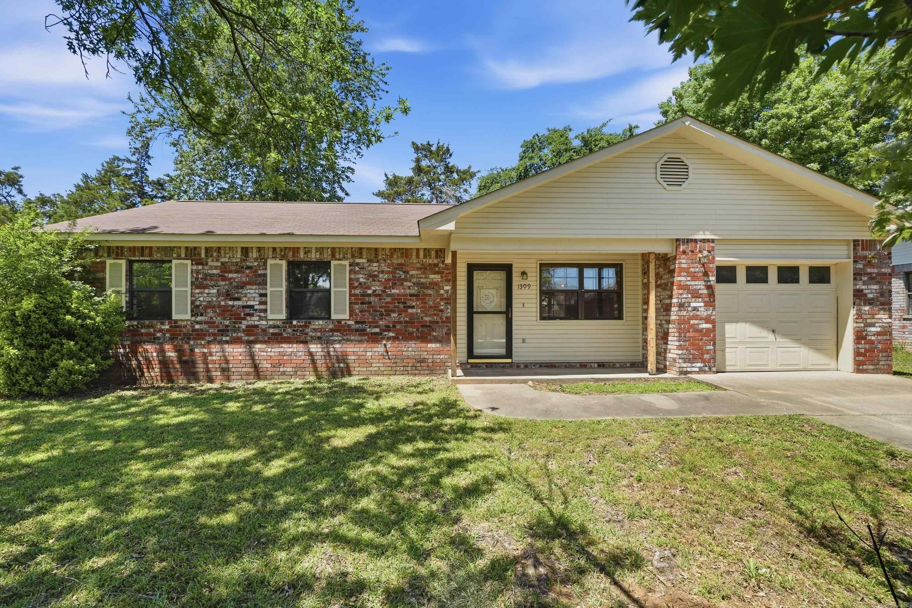 BACK ON MARKET, NO FAULT OF SELLER. Beautiful home that has recently been updated.  Custom backsplash in kitchen with nice gas stove. Open concept in kitchen/living room/dining area. 3 bed/2 bath home with a one car garage. If you are looking for a great home in an excellent Russellville location, this is it.  Easy access to Arkansas Tech, I-40, and downtown Russellville. Fully fenced back yard with a large outbuilding. Back yard also features a concrete patio that is ready for your BBQs and family gatherings. Some photos are virtually staged.