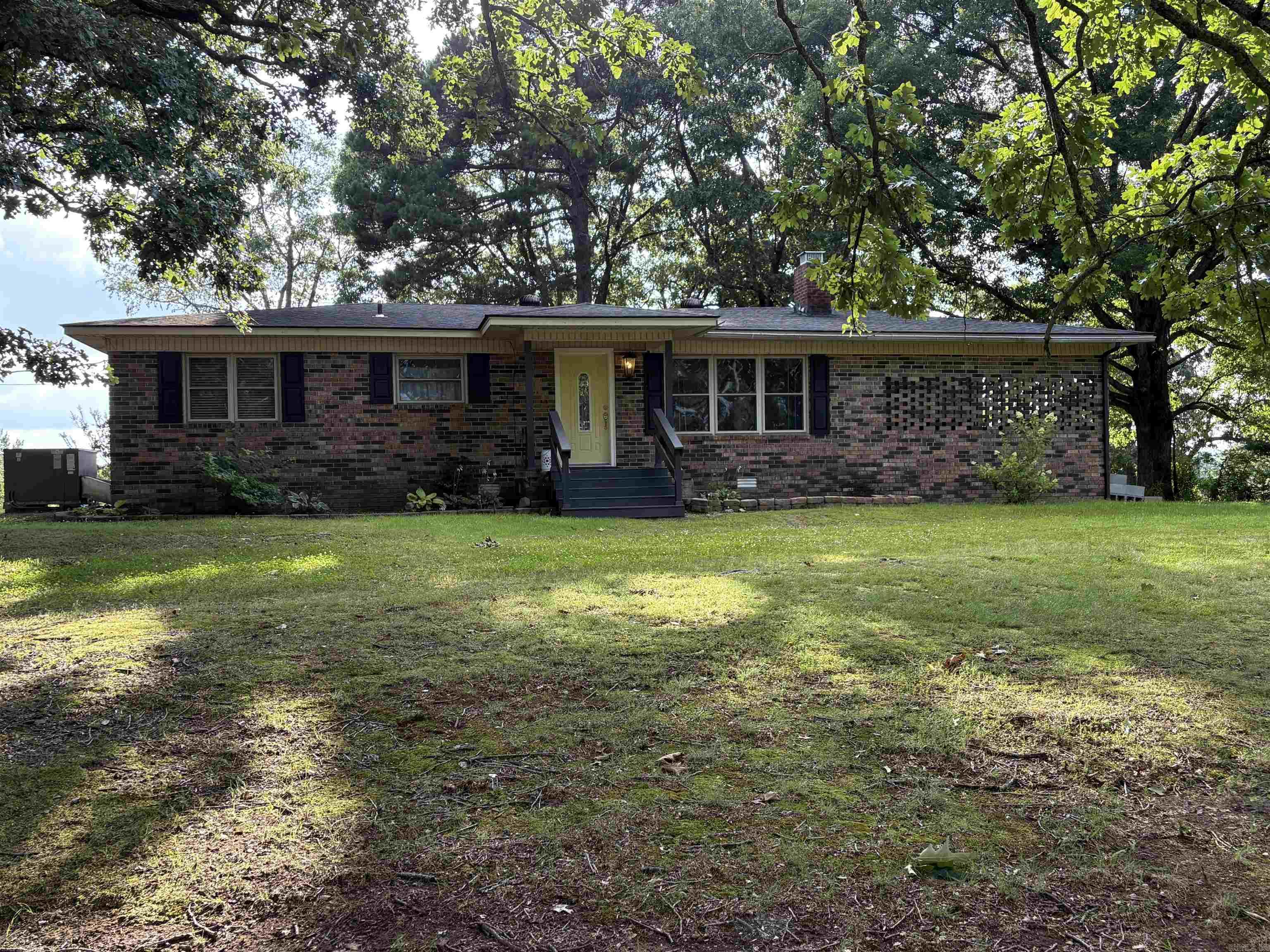 Lovely Brick Home on Paved Road just 2 miles from Mena.  Under large oak trees. Beautiful views of adjoining property and mountains.  Lots of window space for viewing.   Totally updated inside with new paint and appliances as well as a new HVAC system and new water heater.  Original hardwood flooring.  Huge open deck at the rear.  Large concrete pad, about 24' X 24' for whatever purposes you wish. Easy to see.  Call one of our agents.