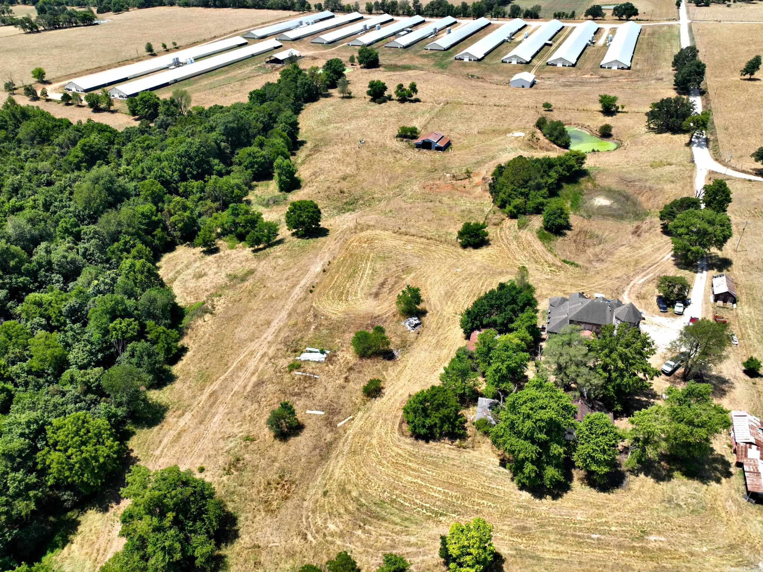 Large, 12 house poultry farm in Northwest Arkansas. Six 55'X600' houses and six 54'X500' houses.  Choretronic 2 & 3 electronic systems. Water storage building, litter barn, 4 generators.  Current Tyson contract.  Cattle barn. Land is fenced and cross fenced for cattle. Large 3,558 square foot home that needs some finishing work.  Four bedrooms & 4 baths. Sale includes a T190 New Holland Tractor and other farm equipment. Complete list of amenities on hand. Income/Expense given only w/offer and acceptance.