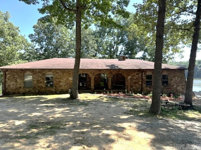 LAKEFRONT HOME ON 1+Acre!  This rock home has 2476 sq ft and was remodeled in 2022 w/new windows, LVP flooring, paint, countertops, backsplash, pantry, stainless appliances, sink, two-tiered deck, black chain link fence and other new touches! Main floor consists of living room w/rock iron fireplace wood burning insert, huge dining room w/bay window overlooking Baltz Lake, kitchen w/stainless appliances and pantry, laundry room w/lots of cabinets leading to a 480 sq ft 2 car garage, 3 bedrooms and 2 bathrooms including master suite w/private bath, walk in shower and closet. The 806 sq ft walk out basement makes the perfect 2 room den, game room/extra bedroom! It’s also plumbed for half bath! The home is very well insulated in the attic and walls and also has an attic fan. Gorgeous arched front porch! The home sits on 3 lots, 2 being on the lake and 1 on Mansker Creek with excellent fishing.  2 storage buildings w/lean-tos and a hoop shed. 18’X4’ above ground, saltwater pool. 2 tiered deck leads to a concrete patio. Back yard is enclosed with a black 5' tall chain link fence with 2 double gates and 1 walk through gate. All this sits on the banks of beautiful 44 acre Baltz Lake!