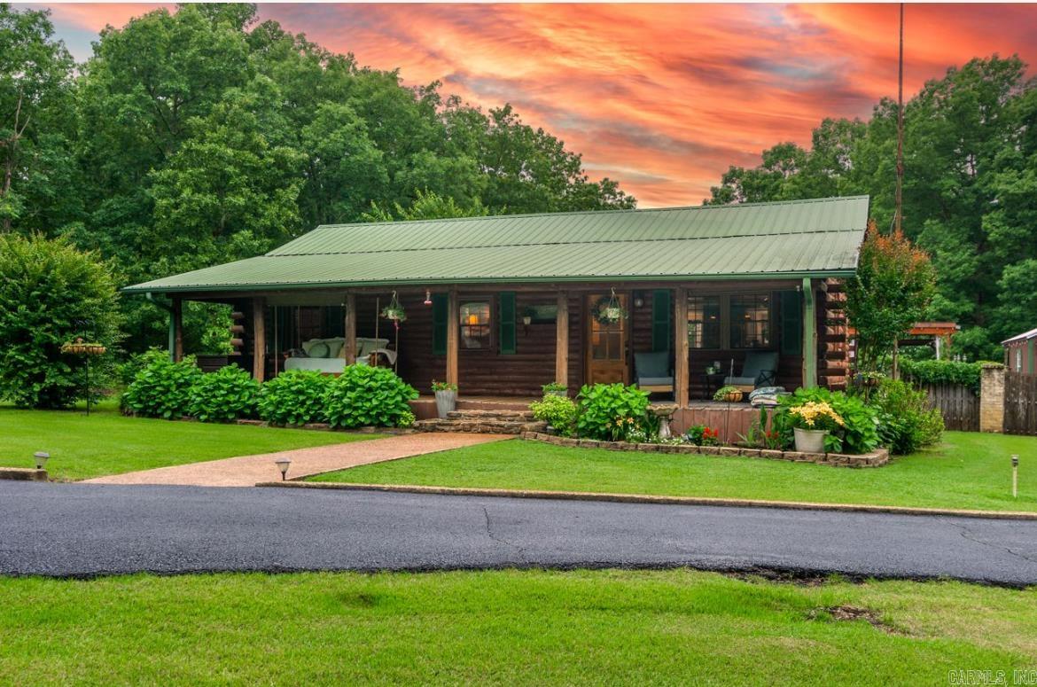 BACK ON THE MARKET DUE TO A CHANGE IN THE SELLERS' CIRCUMSTANCES - NOT DUE TO THE HOME!!  This stunning log cabin-style retreat and property is available due to no fault of its own! Currently under a contingent offer still accepting offers! Call today to set up an appointment!  Nestled on approximately 3.26 acres located at the end of a private road, this property offers the peace and privacy of country living with beautiful views and plenty of space to enjoy. Inside, you'll find a very well-maintained home featuring 2 bedrooms, 2 bathrooms, granite counter tops, spacious living areas, a functional floor plan, and all the charm that made these owners fall in love with it just weeks ago! If you've been looking for a move-in-ready home with a pool and acreage, don't miss your second chance to own this outstanding property! Schedule your private showing today! AGENTS, PLEASE SEE REMARKS!!