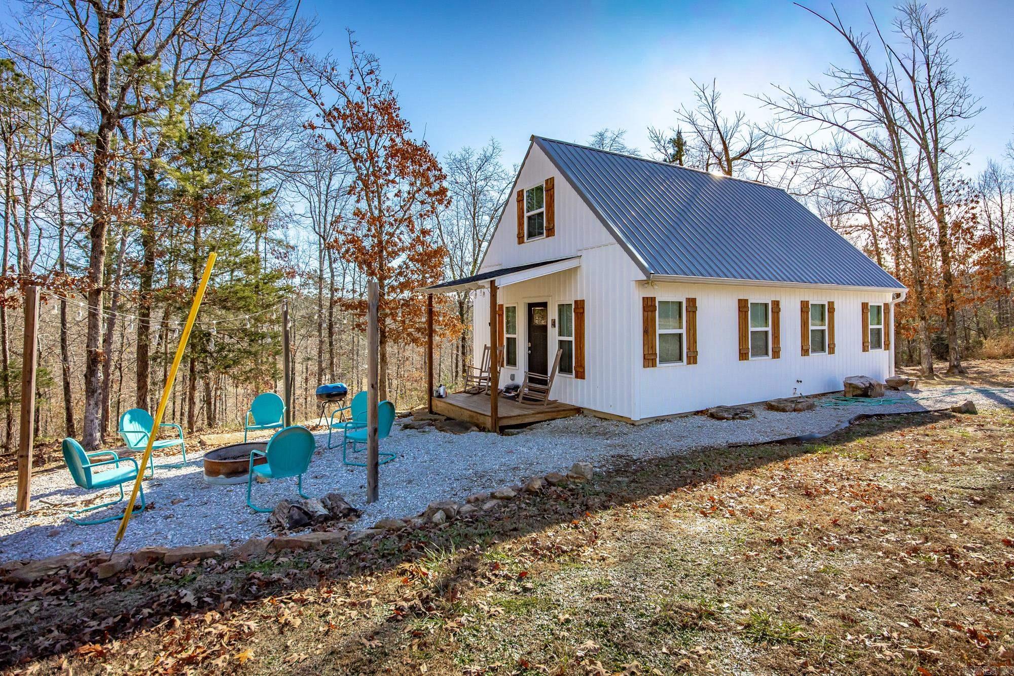 Such an adorable retreat with 2 Cozy Cottages, RV Pad w/50 Amp Hookup & Outdoor Sauna w/outdoor shower – Minutes from Greers Ferry Lake (Close to Hill Creek Marina & Swimming Area). Comes fully equipped  & furnished (everything stays) as this property runs as a successful Short Term rental since 2018! Rent one or both for extra space—ideal for families traveling together but wanting a little privacy. RV pad-Enjoy the amenities of the property while staying in the comfort of your own rig! Sauna - Unwind in the private wood-fired sauna, surrounded by trees - It’s the perfect way to relax after boating, hiking, fishing, or exploring the lake. You’ll love the outdoor setting—Party lights over the fire pit areas for s’mores & reminiscing. Covered porches perfect for morning coffee or evening wine.  See survey online under docs