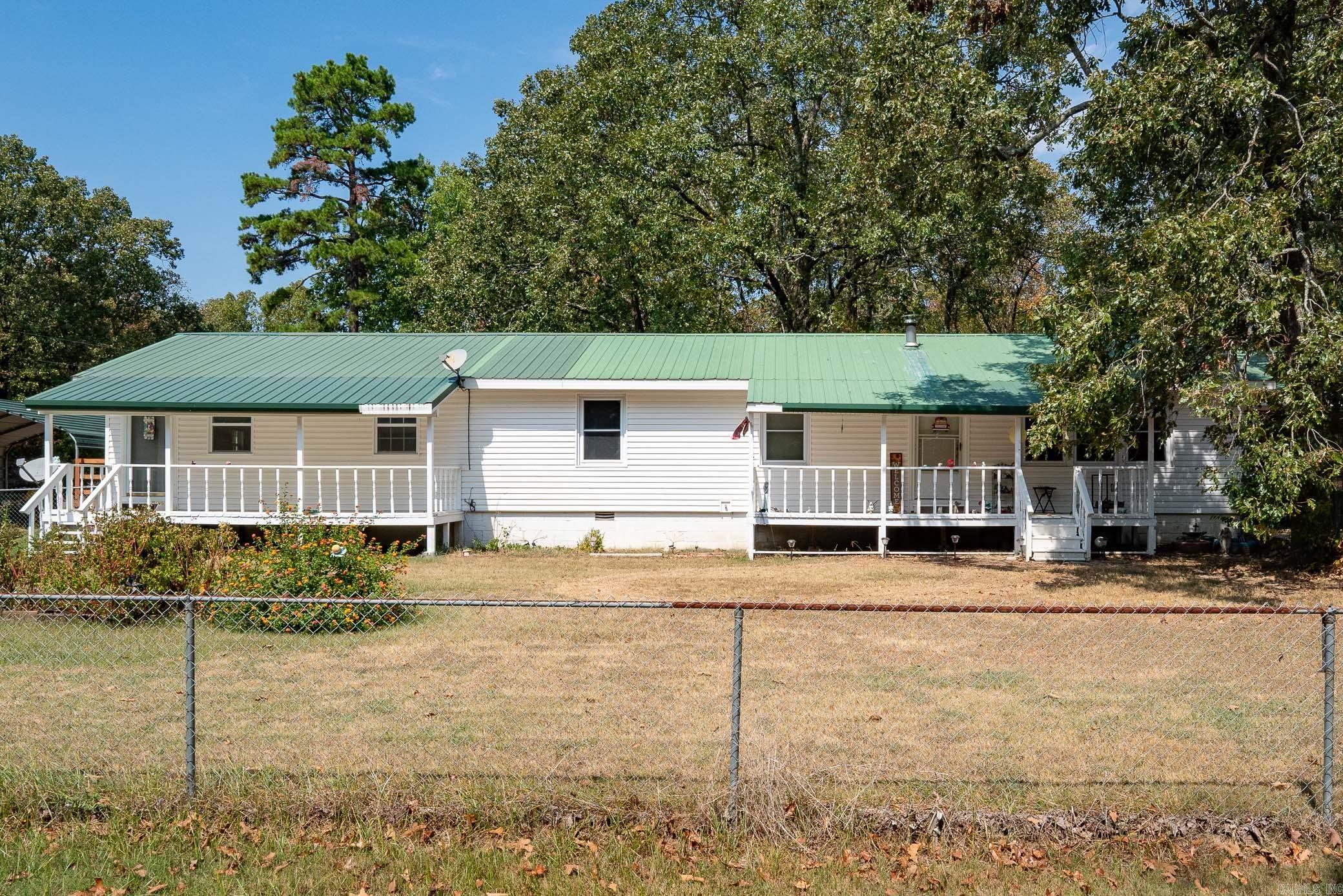 Back on the market due to no fault of the seller! Situated on a spacious 1-acre corner lot, this home features two living areas, 4 beds and 3 full baths. This additional living areas has its own private kitchen, bathroom, washer/dryer hookup, porch, parking, and entrance with ramp. Stay warm in the winter with the wood burning fireplace. The large 28' x 32' shop, carport, and two additional sheds give you ample room for storage and space to work. Low maintenance exterior features a metal roof and vinyl siding. Located just 5 minutes to the Baker-Willis Exit on I-40. *Agents See Remarks*