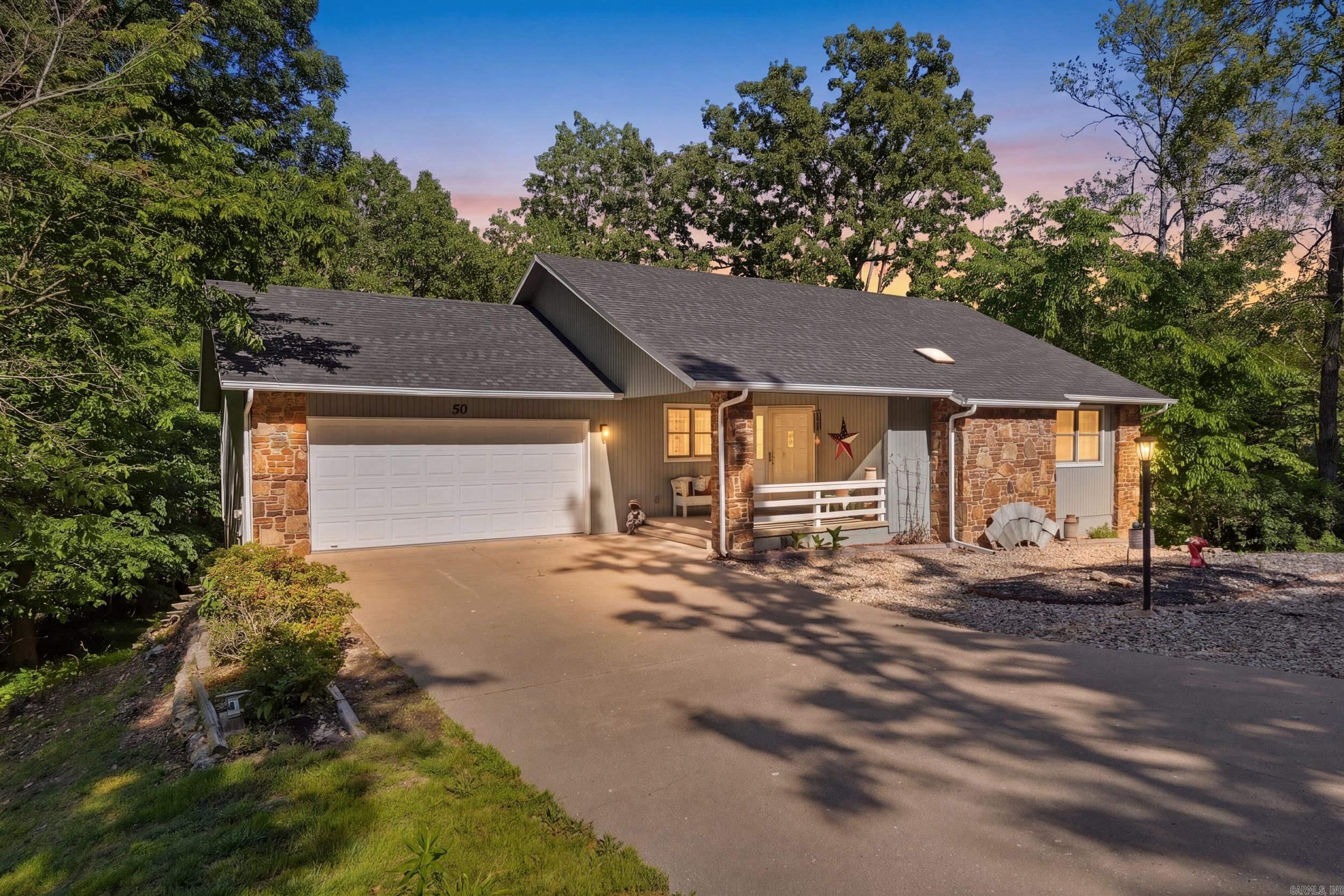 Welcome Home! Charming, updated, and move-in ready! This 2,062 sq ft home sits on a spacious half-acre lot with thoughtful updates throughout. Two bedrooms on the main floor, plus a lower-level bonus suite with a full bath that has its own dedicated parking, no need to navigate stairs. Perfect setup for an in-law suite, guest quarters, or VRBO rental. The walkout basement and brand new back deck open to a peaceful backyard shaded by a natural canopy of foliage with abundant wildlife. Just off the living room, the sunroom offers flexible space for a craft room, home office, or playroom. A 2-car garage plus a 3rd-car covered carport give you plenty of parking for family and guests. Recent updates include: brand new deck, exterior paint (2025), new roof (2022), HVAC (2022), water heater (2024), painted cabinets (2022), engineered hardwood flooring in the living room and sunroom, new appliances and fixtures, and a retaining wall by the carport. Conveniently located minutes from Branchwood Park, Loch Lomond, and both the Highlands and Scottsdale golf courses! *Photos have been virtually staged.