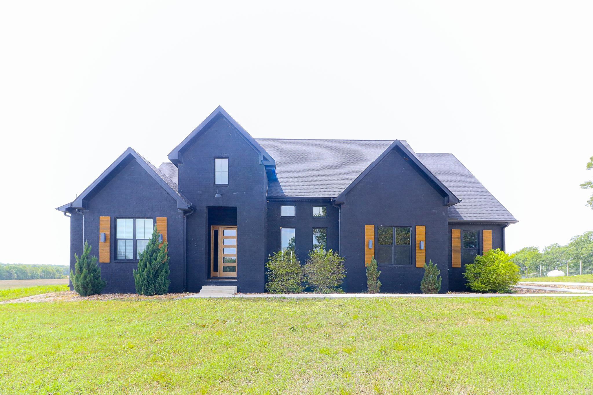 Welcome to your dream home in the highly sought-after Westside School District! Nestled on 3 beautiful acres, this stunning country retreat sits gracefully atop a hill, offering breathtaking, picture-perfect views of the surrounding countryside.    From the moment you arrive, you'll be captivated by the home's warm, modern color palette and gorgeous wooden accents that create an inviting and timeless feel. Inside, vaulted ceilings and tall, elegant doors add character and charm, while natural light pours in to highlight every thoughtful detail.    The kitchen is a true showstopper, featuring a built-in refrigerator and a spacious butler's pantry perfect for entertaining and everyday convenience. Just imagine hosting gatherings or enjoying quiet mornings with everything you need right at your fingertips.    Unwind in the serene screened-in porch, where you can sit back and take in the peaceful scenery that truly looks like a painting. Whether it's sunrise coffee or sunset relaxation, this space is sure to become a favorite.    The home also offers a versatile bonus bedroom and bathroom above the 3-car garage ideal for guests, a private office, or a separate living space.