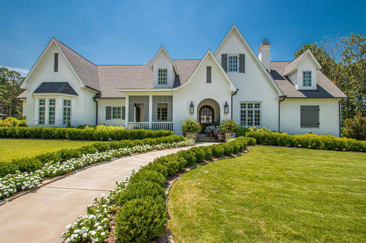 Charming English Country Home in the heart of Chenal! This beautiful custom built home boasts a stunning pool surrounded by Pennsylvania blue stone and waterfall. The sunroom overlooking the pool has a wall of floor to ceiling windows and stone fireplace for a cozy feel. The chef's kitchen is filled with tons of cabinetry, soapstone countertops and equipped with Thermador appliances. Wood walls in main living areas and site finished hardwoods throughout. Custom floor to ceiling design in every room!!