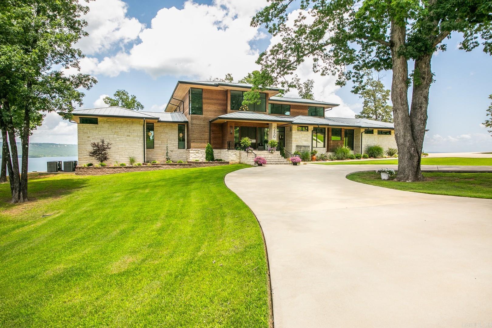 Heber Springs - Stunning lakeview estate on 15 acres w/ private, gated entry. Built in 2022, this 4,058 sq. ft. home has 5 bdr./4.5 baths & a panoramic view from every room. The two downstairs guest bedrooms open to a large patio w/ its own fireplace. In addition to the 4/4.5 home, there is a large in-law suite w/ a handicap friendly bathroom, kitchenette, and its own small patio. There is a generator & safe room. The kitchen has upscale appliances & large walk-in pantry. Master bedroom has electric blinds (as does the living room), & a retractable TV, along w/ a patio. The master bath has heated floors, a walk-in shower, a soaker tub, & his and her closets (with vanity for her). The upstairs bedroom is actually its own suite w/ a seating area, full bath & sleeping quarters, in addition to the large loft at top of the stairs that holds two full-sized couches. In addition to the attached garage, also on the property is a 40’ x 50’ large shop w/ two 12-foot garage doors, a half bath w/ washer & dryer, a heated/cooled office, & more storage – not to mention the same the same great lake view as the home! 16.49 acres, next door to this home, is currently for sale as an option.