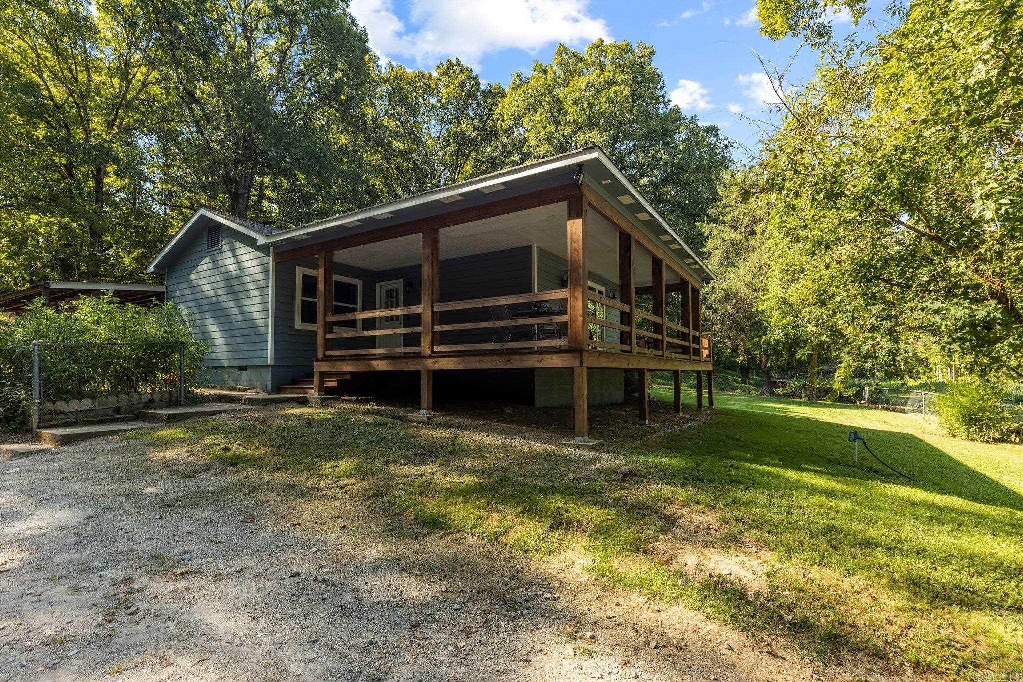 Owner is a licensed real estate agent. Discover peaceful country living on 3.2 acres with this well-kept 4 bedroom, 2 bath home offering nearly 1,700 sq ft of comfortable space. There is even a built in gun safe for your “valuables”. Fully remodeled in 2023, including a new roof and HVAC, this property includes a 2-car attached carport, two additional detached carports, multiple storage buildings, and a 26x40 concrete-block shop with electricity and a wood-burning stove—perfect for projects or equipment. Enjoy a fenced pasture, fenced garden area, chicken coop, fruit & black walnut trees, and plenty of open space for a true homestead setup. Home is on county water and also features a modern dug well for backup. Seller is offering a $5,000 flooring allowance or closing-cost credit with acceptable offer, plus a home warranty for added peace of mind. A rare combination of acreage, usable outbuildings, and move-in ready living just minutes from town.