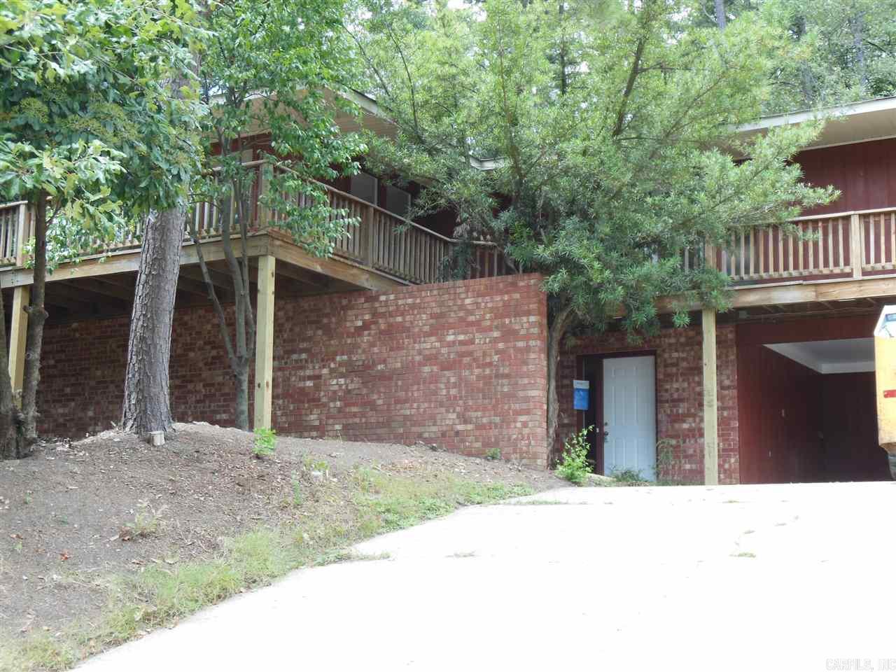 MID CENTURY MODERN IN THE TREES Great architectural style secluded in convenient mid-town location. Spacious dual level four bedroom, 2 1/2 bath home with hard surface floors throughout. Living/dining combination, nicely furnished eat-in kitchen, laundry room, lots of storage, 2 vehicle carport, huge patio, wrap around deck, fenced back yard. Call Marshall Peters & Assoc.  501-414-8340