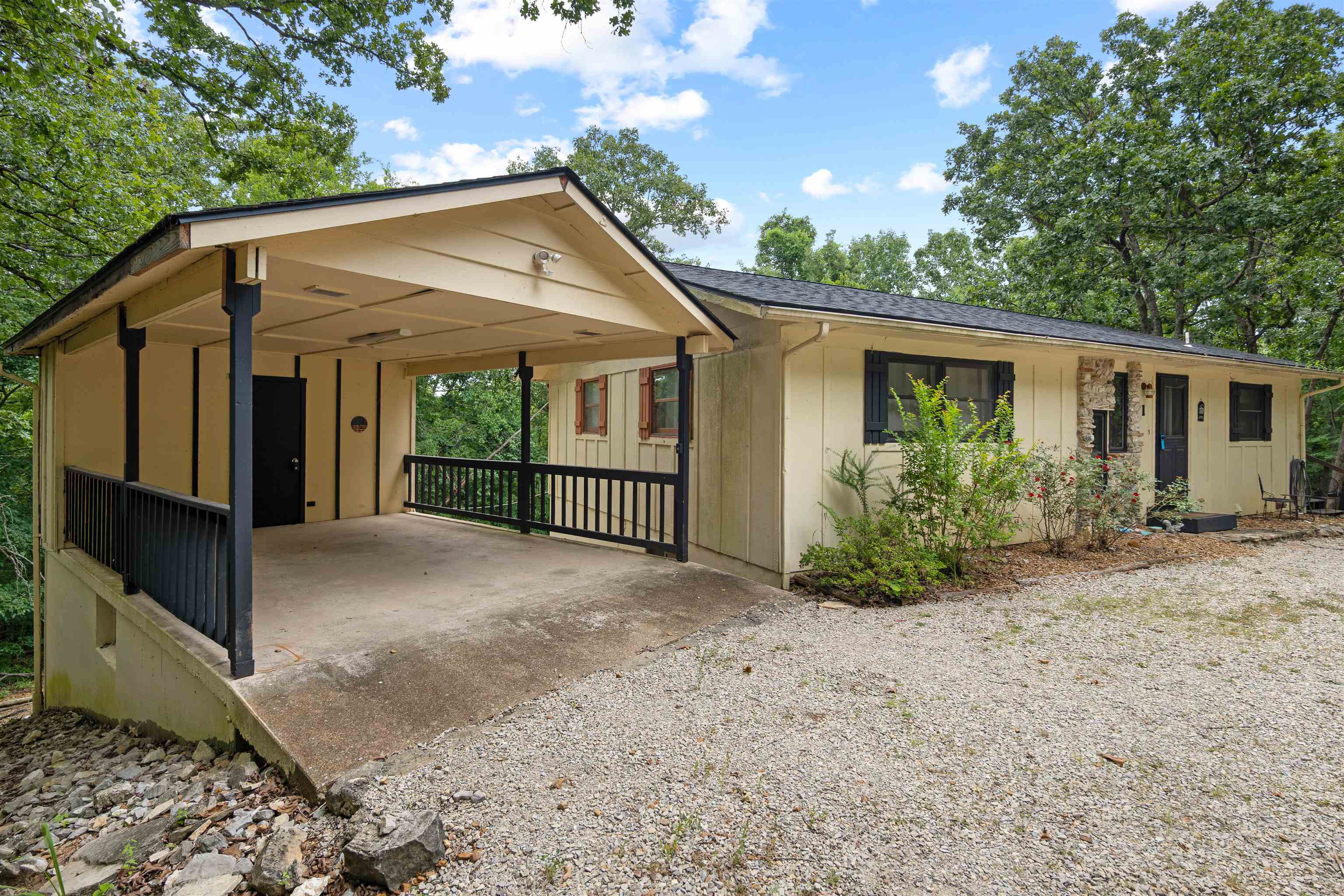 This 2,200+ square foot home has an incredible floor plan with so much to offer!  Used as a very successful short term rental, this home has 4 bedrooms and 2 full bathrooms.  2 bedrooms and a bathroom on the main level, and 2 bedrooms, 1 bathroom, rustic den, and large laundry room on the daylight basement level.  Other features include A well appointed kitchen with plenty of counter space, dining area, large living room, large laundry room, and nice sized bedrooms.  You will love enjoying the peace and quiet of the 2 wooded lots from the wrap around deck or lower level patio!  All new flooring, new lighting, newer roof, and a great storage room under the carport are other features sure to please!  Call your favorite Realtor for a showing today!
