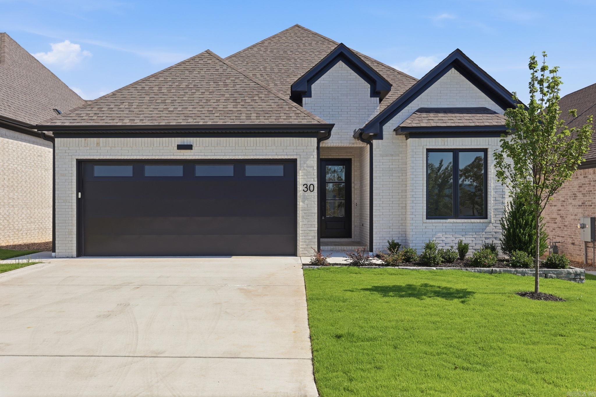 Welcome home to this beautifully crafted 4-bedroom, 3-bath residence located in one of West Little Rock's newest neighborhoods.  Step inside and be greeted by soaring 12-foot ceilings that create a bright, open, and inviting atmosphere. The spacious primary suite serves as a luxurious retreat, featuring an oversized walk-in shower, soaking tub, private water closet, and a large custom walk-in closet designed to accommodate any wardrobe. Just off the entry, the front bedroom is filled with natural light and makes an ideal home office, guest room, or flex space. Two additional generously sized bedrooms share a thoughtfully designed full bath, offering comfort and privacy for family or guests. At the heart of the home, the chef's kitchen is designed for both everyday living and entertaining, featuring a large island, quality finishes, abundant workspace, and a spacious pantry for extra storage. The open-concept living and dining areas flow seamlessly to the outdoors through sliding glass doors, leading to a covered patio with an outdoor fireplace—the perfect place to relax and enjoy peaceful evenings while taking in beautiful mountain views. Call to schedule your private showing.