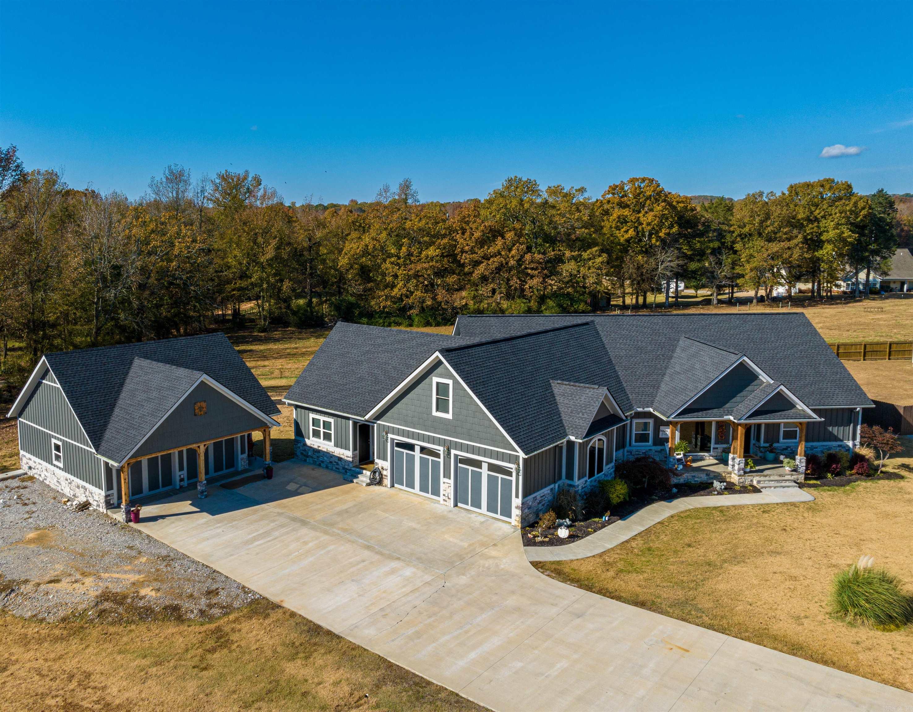 Custom built in 2020, with about 4,949 sq ft under the roof; this home is a must-see!Curb appeal, shop is heated and cooled with a mini split, about 900 sq ft +/- sitting to the side of the house, which also has a half bathroom in it and could easily be converted into a cute inlaw/guest house, has 2 rollup doors.Home has vaulted ceiling, sliding glass doors leading out back to the covered back porch, a gas log fireplace with stacked rock, custom farm-style doors on the entrance to the formal dining room where you have a wall of built-ins and large windows for natural light.Just off the living room, you have the primary suite, nice and roomy with a gorgeous accent wall, opening directly up to the primary bathroom, a nice, large heated jacuzzi tub for 2 in the primary bathroom, custom double vanities, a toilet room, a large his and hers closet, and a huge custom walk-in shower.Large kitchen has a large island with a nice apron, farm sink, gas cook stove, pantry and stainless appliances with eat in area.Another bath, 3 rooms on main level with the laundry off garage.Upstairs is a living room, full bathroom and a bedroom.Please see additional info for full details.