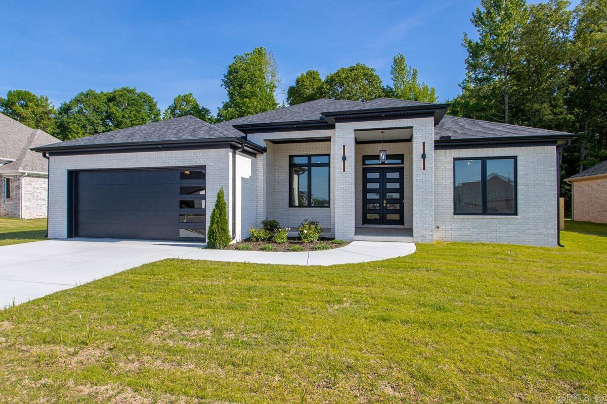 Welcome home! This brand-new 3-bedroom, 2.5-bathroom modern residence is sophisticated, intentional and entirely turnkey! Crafted with an emphasis on light and volume, the residence features striking tall ceilings in both the main living area and the versatile bonus room/office, creating an immediate sense of grand scale. Elegant, high-end finishes are illuminated by strategically placed transom windows that flood the interior with curated natural light. The primary suite serves as a private sanctuary, boasting an elite, spa-inspired bathroom complete with a deep soaking tub, a custom walk-in tile shower, stunning illuminated mirrors, and spacious dual closets. The seamless indoor-outdoor flow leads to an expansive covered back patio, perfect for entertaining or quiet mornings. Situated on a premier lot that backs up to mature woods, you’ll enjoy a level of seclusion rarely found in new builds, complete with a privacy fence already installed for immediate peace of mind. Blending clean architectural lines with premium comfort, this home is a masterclass in modern living!