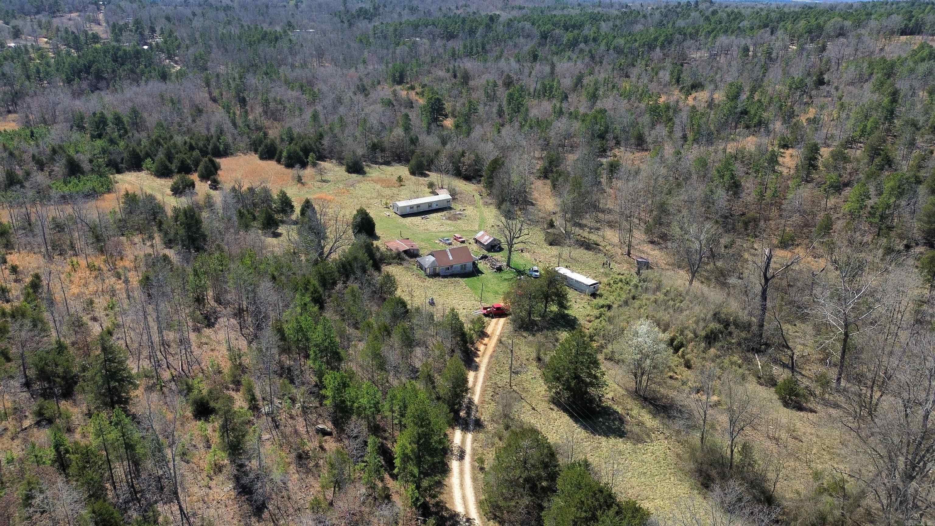 65 +/- Acres with Creek, Pond, and Fixer-Upper Mobile Home in Arkansas!  This 65 +/- acre property in Oxford, Arkansas, offers a mix of open fields and wooded areas, making it an excellent opportunity for hunting, farming, or building. The land features a year-round spring-fed creek, a pond, and large fields ideal for livestock or recreational use.  A 960 sq. ft. single-wide mobile home, built in 1988, sits on the property and is livable but needs some work. Additionally, there is an old house that will need to be torn down. Utilities are already in place, including power and city water.  Located just minutes from Oxford, this property provides a great combination of privacy and convenience. Whether you're looking for a hunting retreat, farmland, or a homesite with utilities already in place, this acreage has plenty of potential. PRICED TO SELL AT $149,900.