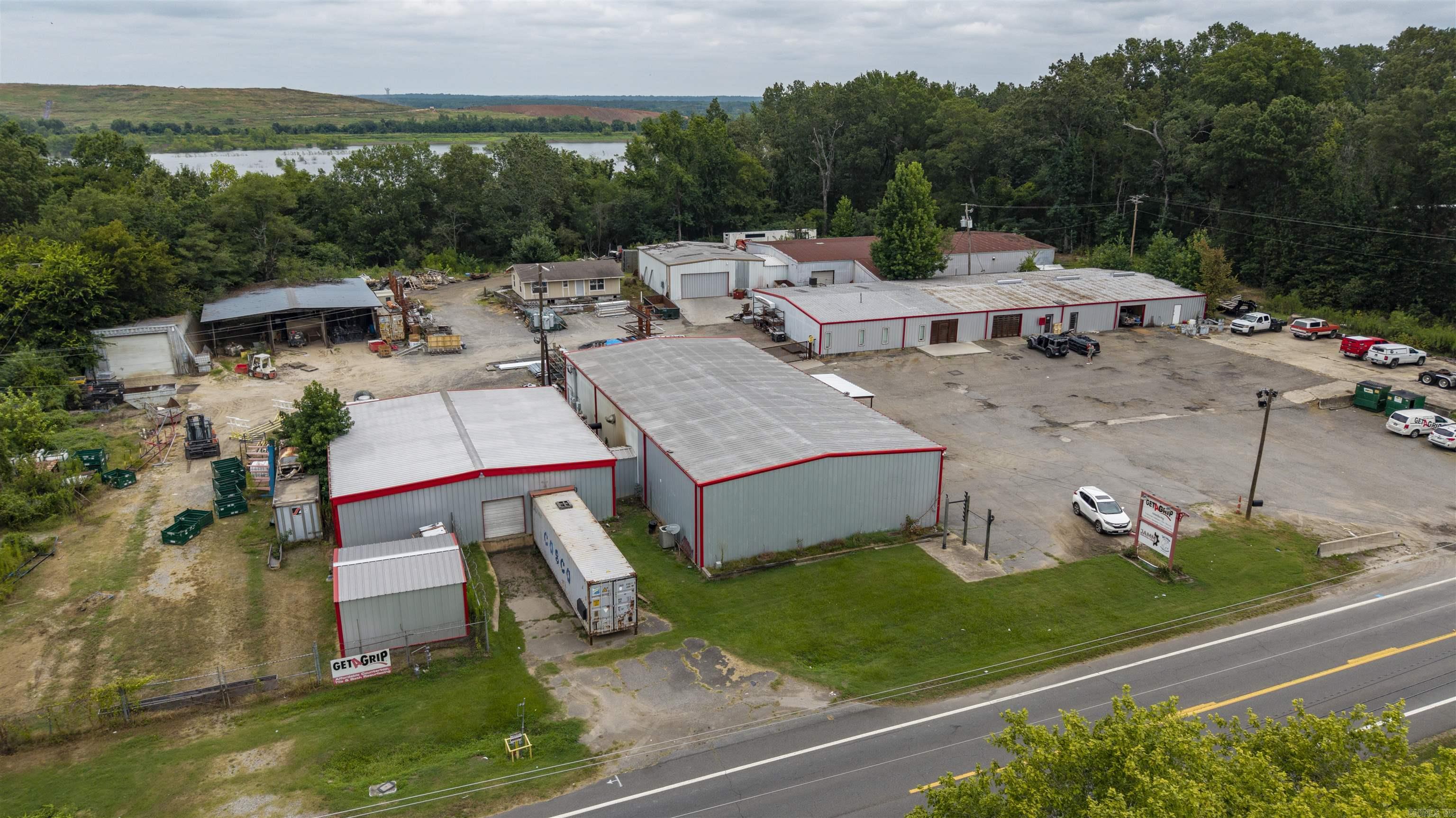 Rare commercial opportunity on 3.77 acres in North Little Rock/Jacksonville Area featuring 6 heated metal buildings totaling over 27,000 SF, plus a 1,200 SF unfinished home and 60'x60' covered storage area. 490' Frontage on AR Hwy 161.  Buildings 1 & 2 include a 60'x150' and attached 60'x120' metal structure with loading dock, powder coating oven, 3-phase 480V power, and upstairs apartment. Building 3 is 50’x60’, Building 4 is 50’x100’, Building 5 is 50’x55’—all heated. Building 6 is a 30’x60’ insulated, heated silo. Some buildings have air-conditioned space. Ideal for manufacturing, warehouse, distribution, or contractor use. Convenient to I-440, I-40, Little Rock Port, and airport.