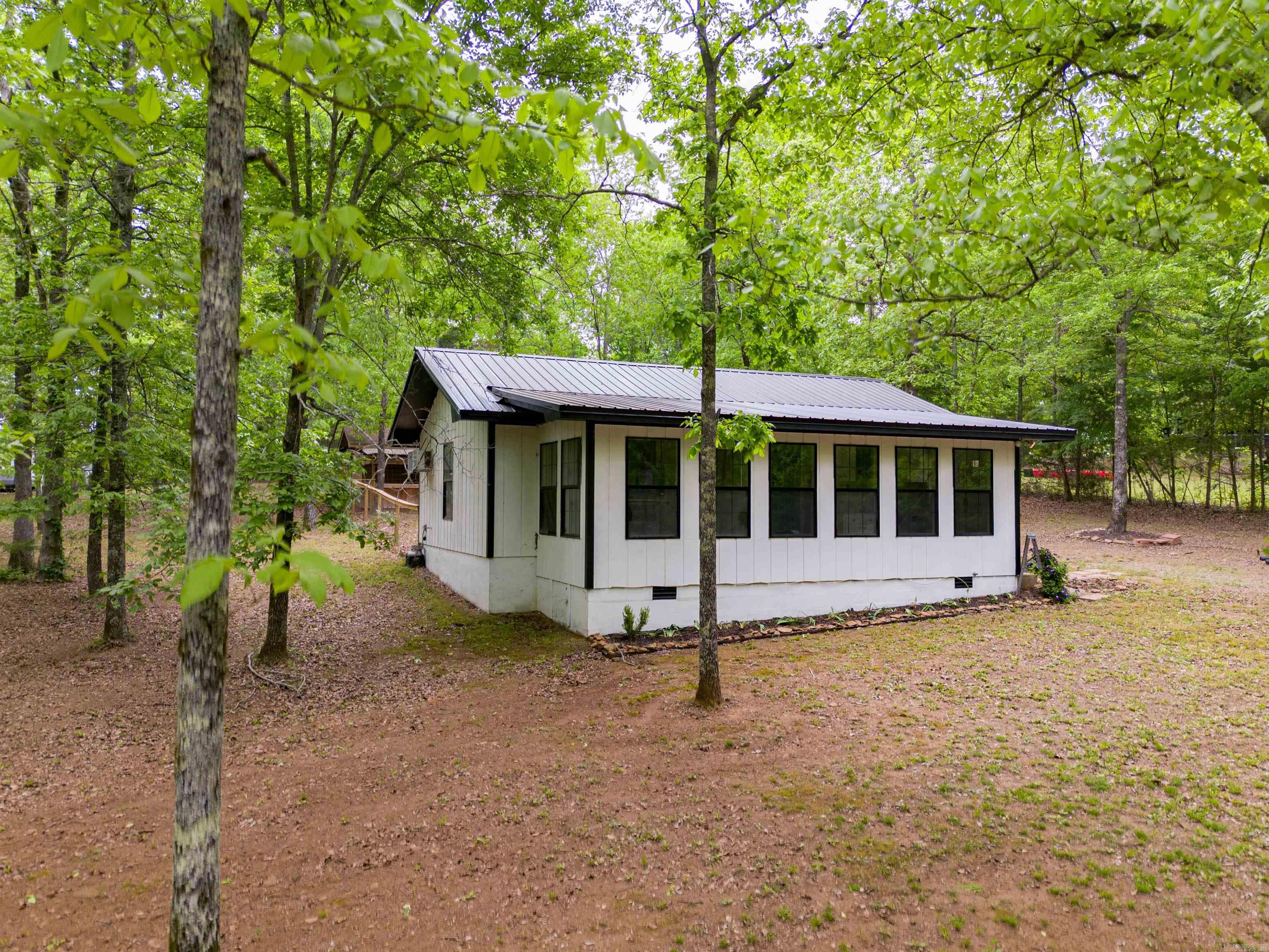 Looking for a peaceful retreat to escape? Considering an investment property? Wanting to downsize?   This great little home has been updated and refreshed while maintaining the open floor plan!! New flooring throughout, new metal roof, and great dog pen ready for your pup! This property also has a building that could be used for a garage, shop, or storage. ALL OF THIS while being close to a nice fishing lake!!