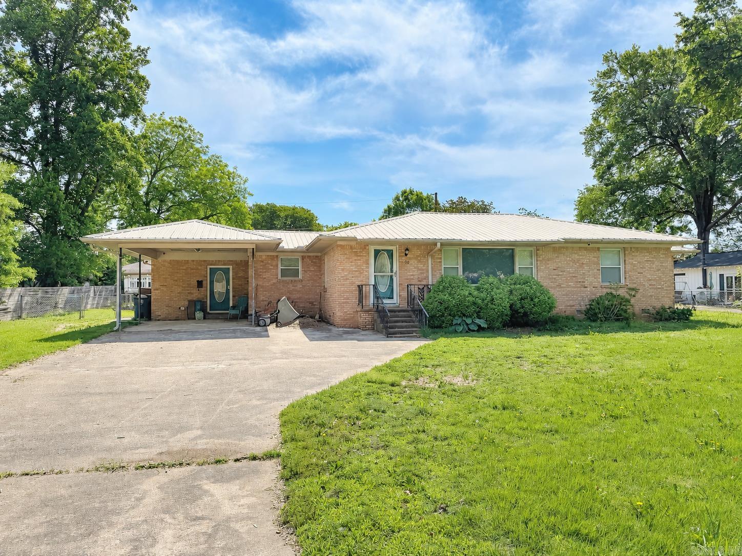 Updated and remodeled 3 bedroom and 3 bathroom home on Searcy's west side.  Fully fenced front and backyard with divider ideal for pets. Metal roof.  Kitchen has ample cabinet and counter space and a gas range.  Refrigerator conveys with the home. There is also a bight and large combination kitchen and dinning room.  The living room also has multiple windows to allow in light with luxury vinyl tile throughout the home. There is a mudroom at the carport entrance and back bedroom/bathroom has a separate side entrance that could have rental income potential.  Gas water heater replaced in 2022 and gas furnace in 2020.  Backyard has a 10x15 shed.