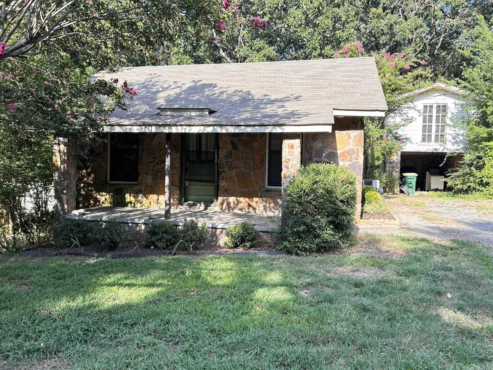 Look at this adorable native stone cottage! The lot is 1/3 of an acre. 2 bedrooms/1 bath. The primary bedroom has room for a sitting area. New counter top and backsplash. It has a great concrete patio out back and a lovely porch out front. The one car carport has a room above it that could make a wonderful studio apartment. Sf taken from tax records, so please verify. House to be sold as-is.