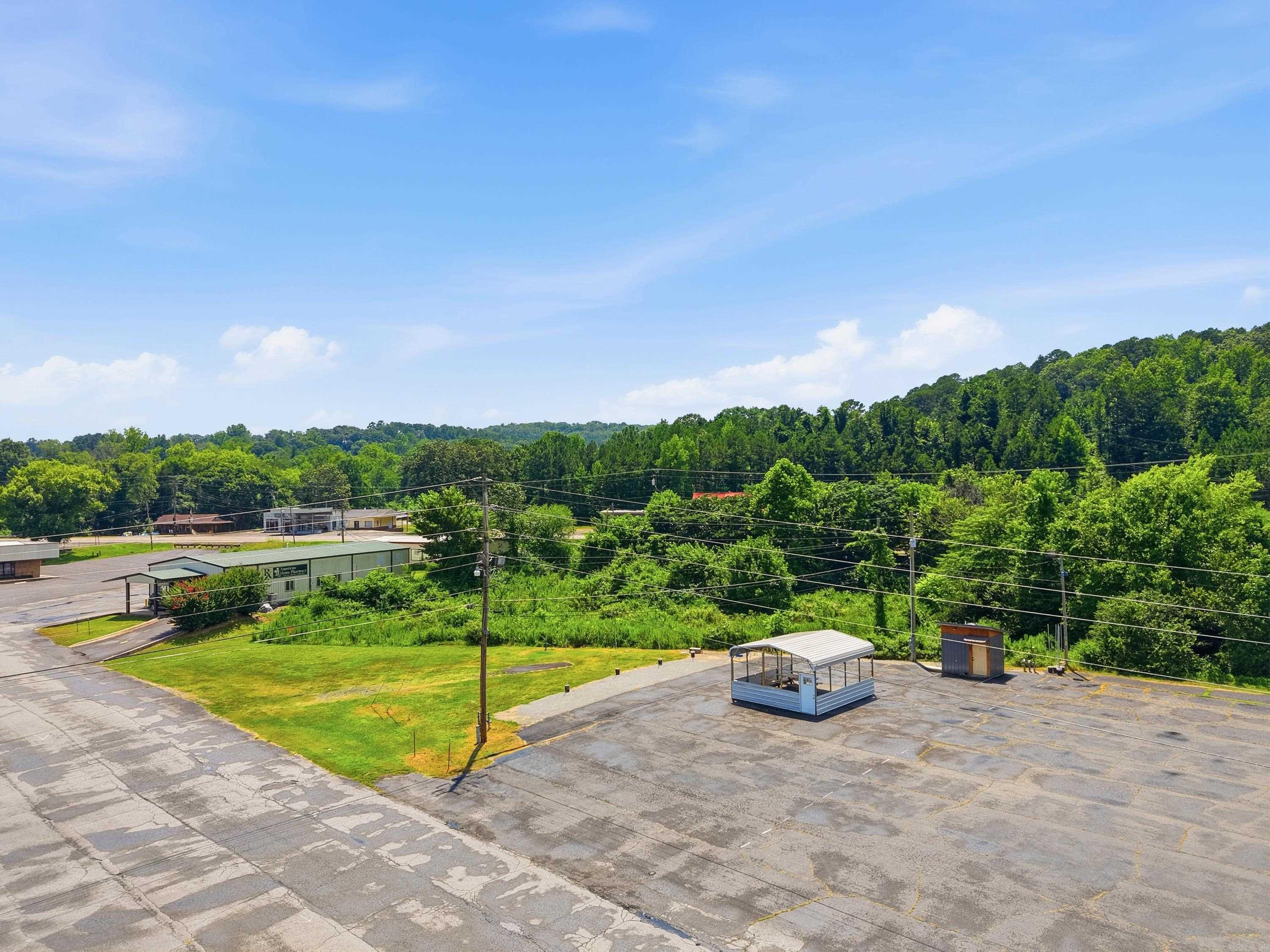 This 0.39+/-acre paved city lot is fully equipped and ready for a variety of commercial uses. Previously operated as a successful food truck court, the property features four 50-amp electrical hookups, two 110-volt outlets, two water hookups, and two gray water clean-out connections for added convenience. A bathroom building conveys with the sale, providing additional value and functionality. The portable carport does not convey. Ideally located close to shopping, and everyday conveniences, this property offers an excellent opportunity to continue operating as a food truck venue or explore other permitted commercial possibilities. The previous owner rented spaces for $400-$450 per month, $200-$250 per week, or $50 per day, demonstrating its income-producing potential. Flood insurance is required. Whether you’re an investor or entrepreneur, this property is ready for its next owner.