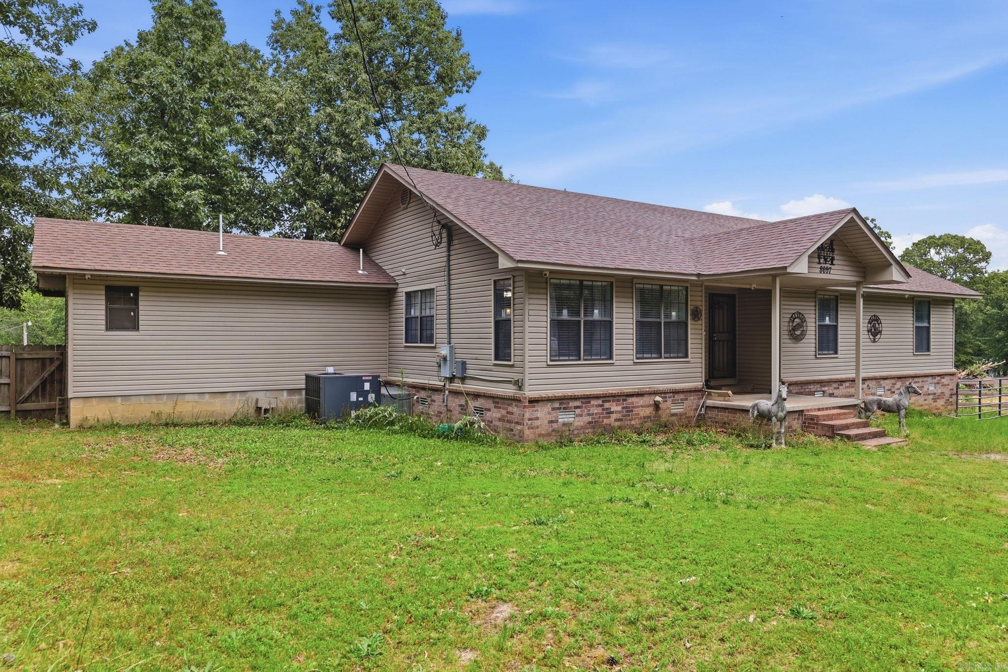 Spacious country living with room for both you and your animals! This 3 bedroom, 2 bath home sits on approximately 3.51 beautiful acres and offers a unique blend of comfort and functionality. Inside, you’ll find a dedicated dog room complete with a raised bathtub for easy pet grooming. The large back deck is perfect for relaxing or entertaining while enjoying the peaceful surroundings. Horse lovers will appreciate the small riding arena and barn with stall walls already in place, ready for finishing touches. Additional features include a security system with cameras for added peace of mind. Washer, dryer, and refrigerator all convey with acceptable offer. Enjoy the space, privacy, and endless possibilities this property has to offer!