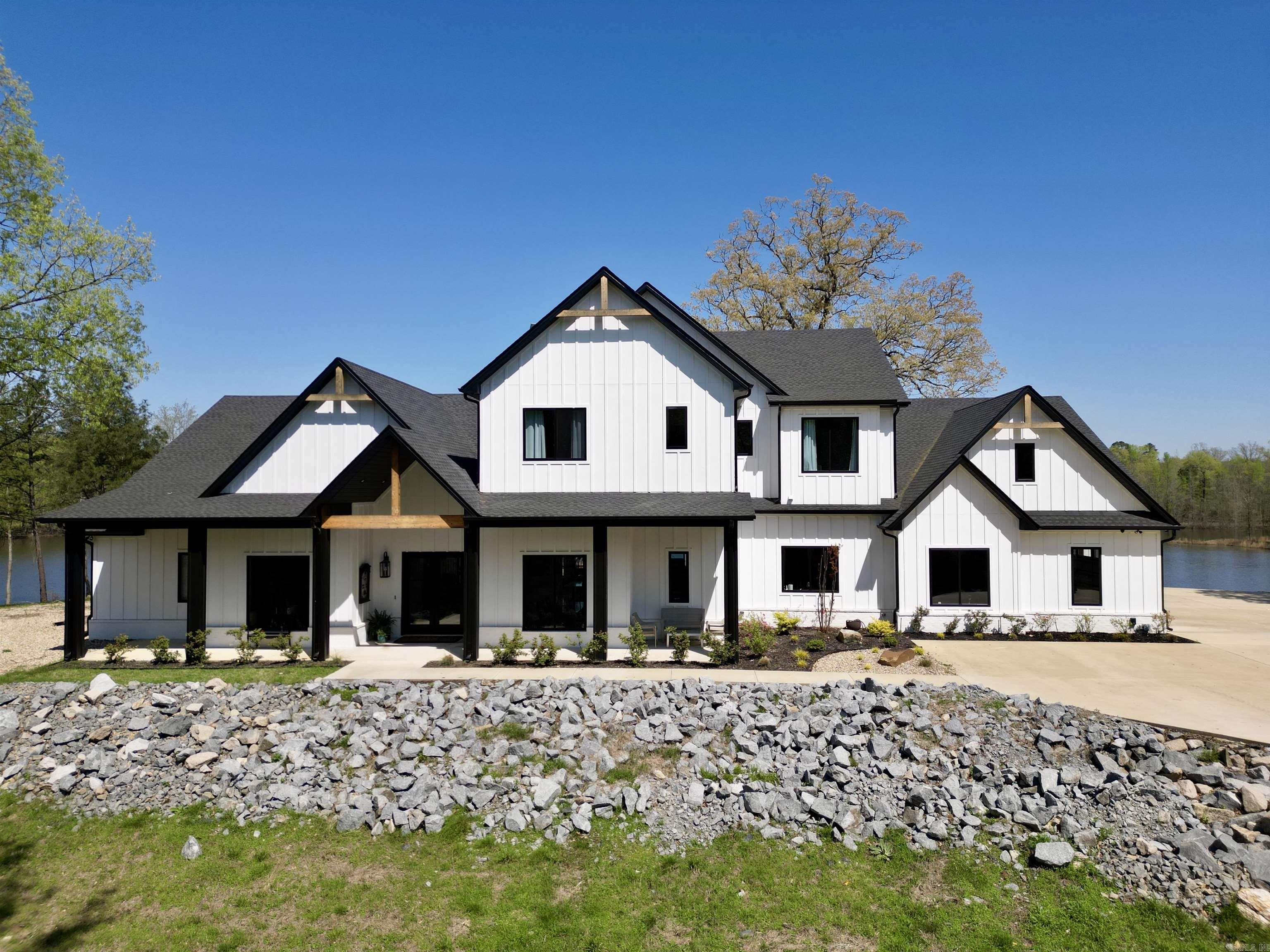 This property is truly a one of a kind place.  Located in West Little Rock, just 7.5 miles to Bass Pro Shops, 8.5 miles to Promenade at Chenal, and 17 miles to downtown L.R.  The main house boasts 5810 sq. ft., it has 6 bedrooms, 5 1/2 baths, formal dining, office, an amazing upstairs gathering room that is central to each of the upstairs bedrooms.  An amazing master suite with soaking tub, huge walk in shower room, and the dream master closet.  Amazing views of the private lake abound.  The kitchen has spared nothing.  Beautiful quartz counter tops, top of the line Kitchen Aid appliances including the 6 burner double oven gas range, ice maker and double door refrigerator/freezer.  In the living room the vaulted ceilings with exposed beams offers a great place for entertaining or having family gatherings.  If it gets to crowded just step out back onto the covered patio with outdoor kitchen and enjoy the view of your very own 25 acre lake.  There is a safe room located inside the huge 4 car garage, of which one space is currently set up as the exercise room.  Prewiring for an electric charging station.  120 ac. & homes $2.99m or 65 ac & homes $2.4m. Beautiful 2nd home as well.