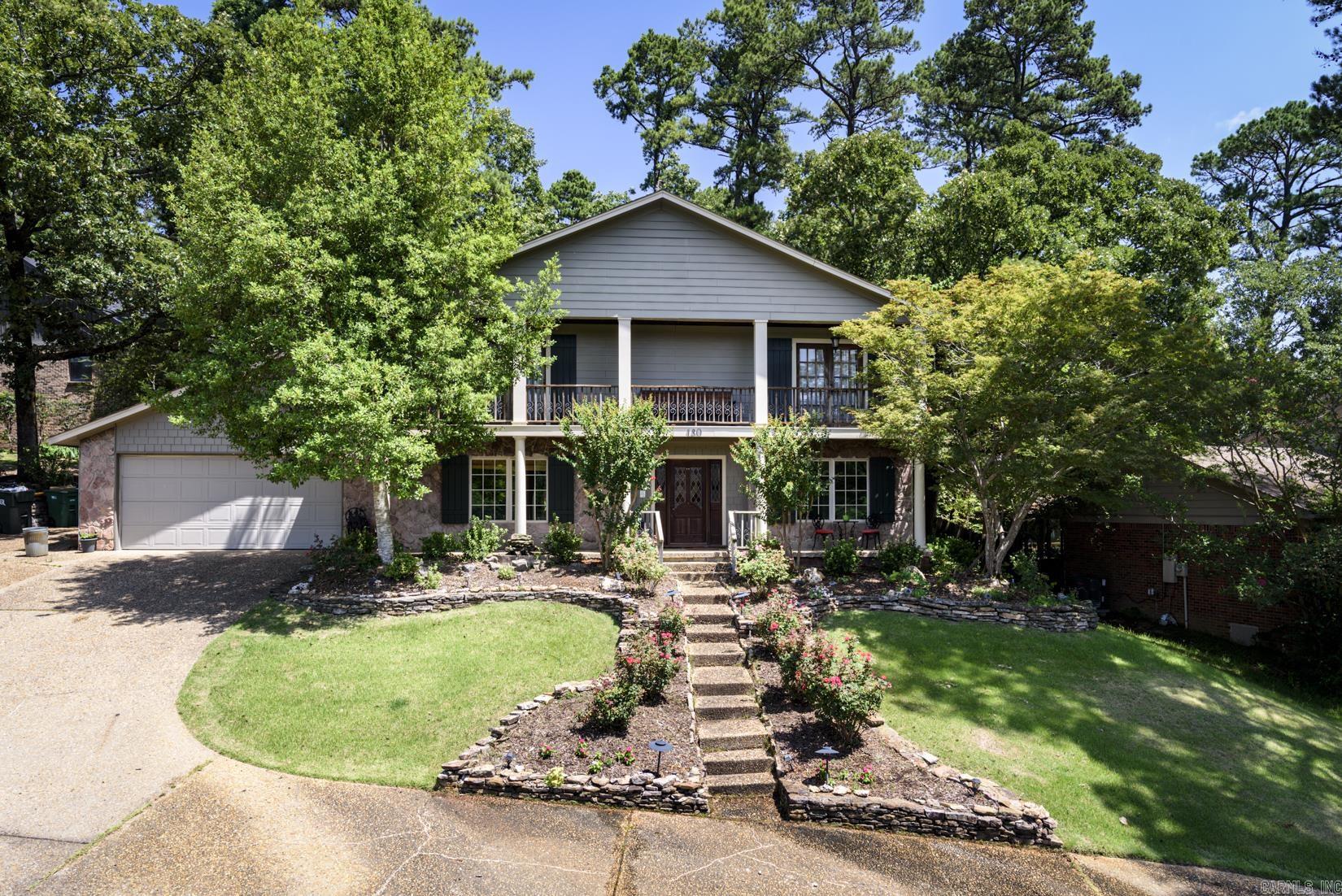 Spectacular 2 story, 4 BR, 2.5 bath home situated on a corner hillside lot in WLR'S highly desirable Pebble Beach offers privacy, space and beautiful views. The fenced backyard is a true oasis, thoughtfully landscaped w/tranquil waterfalls, picturesque koi ponds, charming pergola & stone patio create the perfect setting for relaxing or  entertaining. Inside, the main level features beautiful hardwood flooring, half bath, family room w/gas log fireplace & built-ins. Adjacent is a gourmet kitchen w/breakfast bar, abundant off-white cabinetry, granite countertops & top of the line stainless steel appliances opening to a wonderful sunroom w/floor to ceiling windows. The formal DR & LR are close by. A large laundry room w/built-ins, sink & granite countertops is convenient to the main living area. Upstairs, another beautiful sunroom is adjacent to a guest BR. The primary suite w/spacious bath, vanity, walk-in shower & walk-in closet features french doors that open onto a private balcony where you can take in the panoramic views of the surrounding countryside.  All 4 upstairs BR's are carpeted. A full bath is convenient to the additional 3 BR's. Roof replaced in 2019.