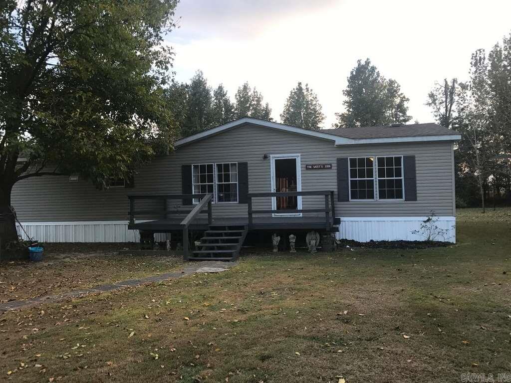 The home has new laminate, paint, kitchen faucet, remote ceiling fans, carpet in bedrooms, and roof is 5 years old.