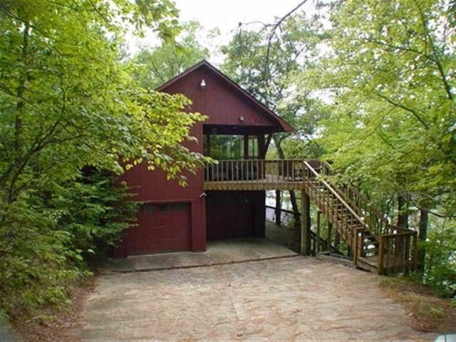 This Waterfront Home offers the serenity and privacy you have been looking for! Nestled in the trees with very little yard work, this 4/2.5 lake home has vaulted ceilings, two fireplaces, three decks, covered boat dock with lift and swim platform. Many recent updates make this a very special opportunity for you to take advantage of! High efficiency HVAC, granite counters, stainless steel appliances, exterior paint, water heater, roof and much more. Year round water and walls of glass for your pleasure.