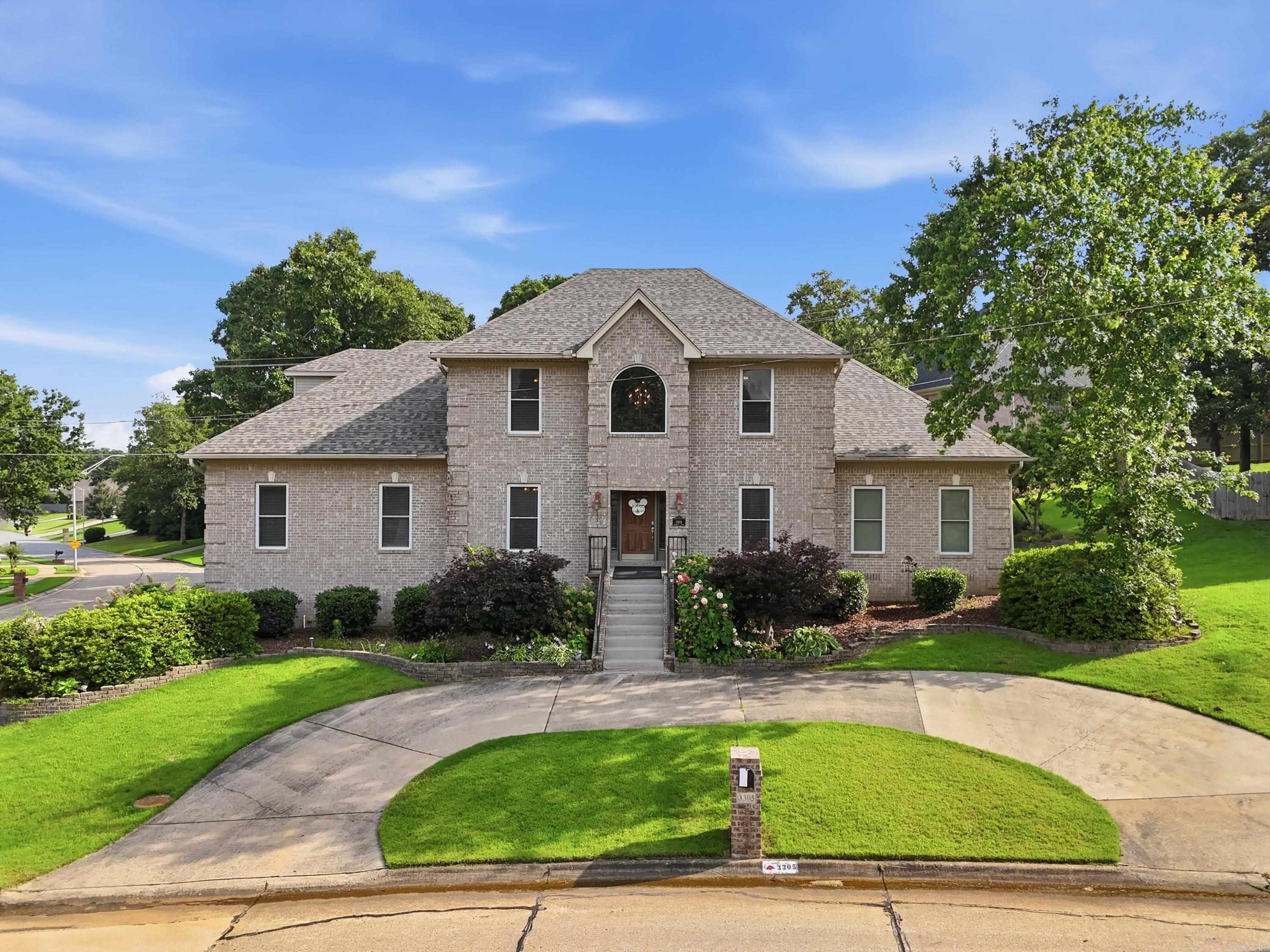 This beautifully designed custom home combines quality craftsmanship, generous living space, and a roof that is less than one year old. Nestled in a desirable neighborhood with easy access to shopping, dining, and commuting routes, the home features soaring ceilings, elegant crown molding, hardwood flooring, and a spacious open-concept floor plan. The updated kitchen is equipped with quartz countertops, double ovens, a built-in ice maker, and overlooks the inviting living room with a cozy fireplace. The main level includes a luxurious primary suite, while upstairs offers a second primary suite, two additional bedrooms, a full bath, and an expansive game room. Additional features include a covered deck, 3-car garage, sprinkler system, central vacuum, circle drive, oversized laundry room with space for a craft or hobby area, and abundant walk-in attic storage.