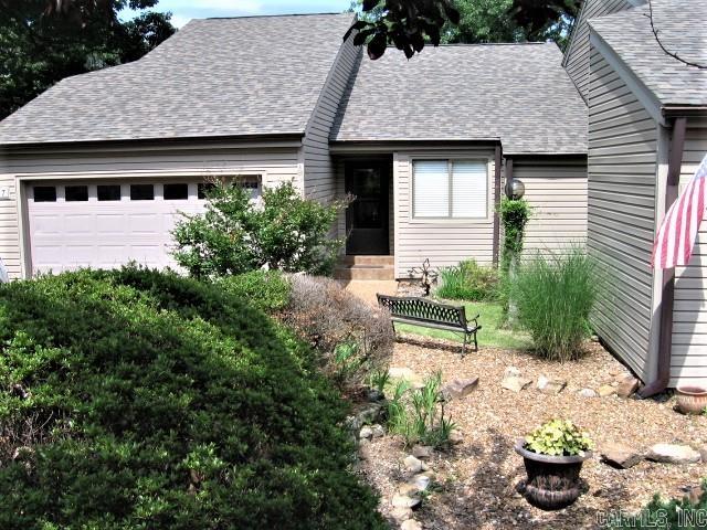 BEAUTIFUL GOLF COURSE TOWNHOUSE with 2 levels of living space, plus golf cart garage.  Country Club Ridge unit is on the 18th fairway, overlooking a water feature.  The main level has living-dining area with gas fireplace, pitched ceiling.  Step out into a large Sunroom to watch the golfers, or to enjoy the view.      Kitchen has nice black appliances, tile-topped counters, & is open to the dining area. Master suite also has access to the sunroom, and second BR is also used as an office. The entrance from garage and laundry room are on this main level.   Downstairs offers another great living room, 2 BR, 1 1/2 Ba, a wet bar,  & access outside to a deck.  Owners have game tables, cozy furniture, and dining area on this level as well. NOTE:  Most furniture is included, but Asian-design furniture and art pieces are EXCLUDED.