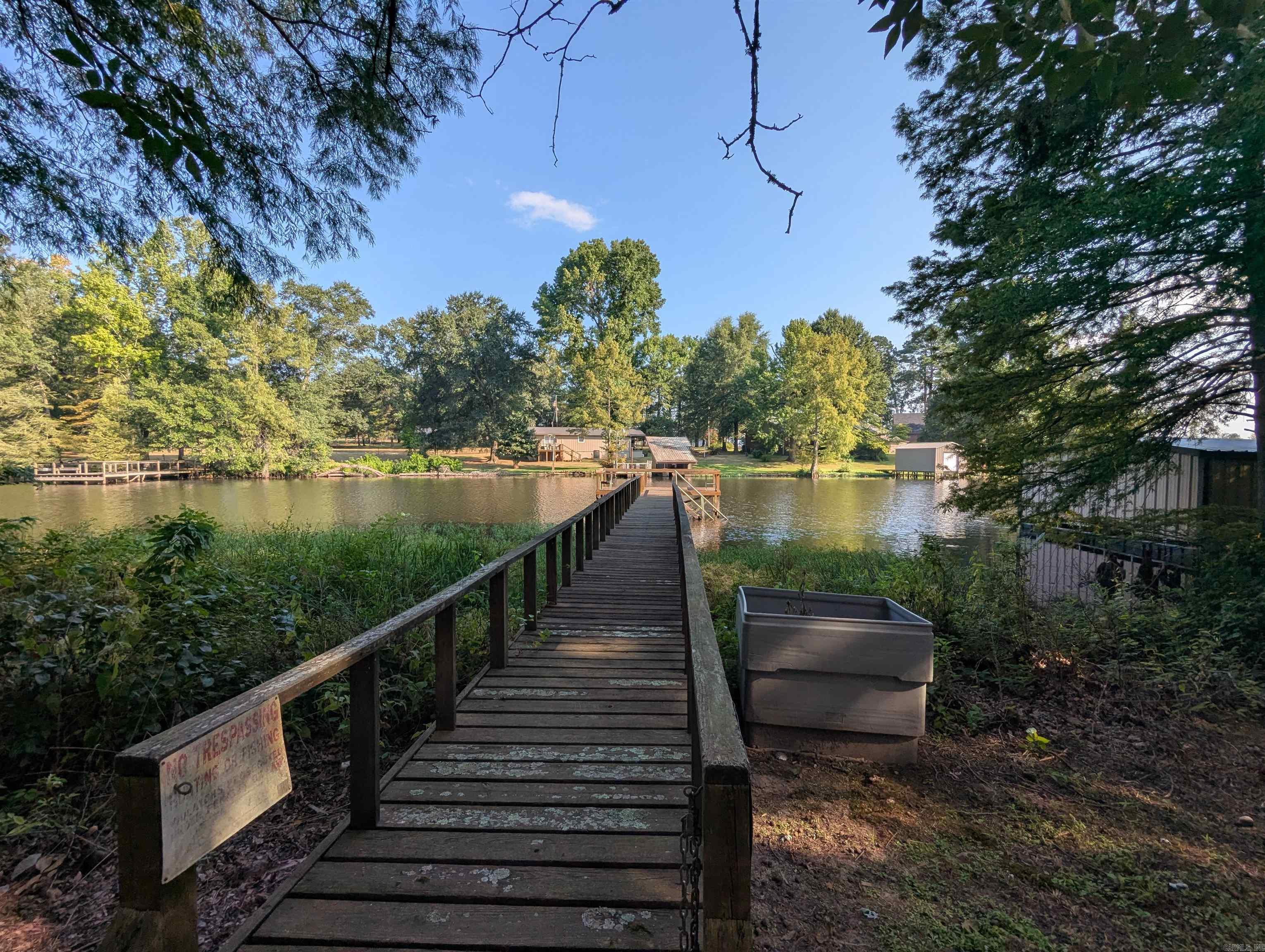 This is a well maintained home that is not typical for its age.  Move in ready, clean large 16 x 16 sunroom facing the lake.  Boat dock is in good condition and in a great location for crappie fishing.  Carport has a storage building with an attached wood deck and covered front porch. Relatively flat yard with flower beds and decorations. Kitchen appliances are newer and upgraded.  This is a rare find on the lake with too many good things to pass up.  PLEASE NO TRESPASSING WITHOUT APPOINTMENT AND REAL ESTATE AGENT PRESENT.