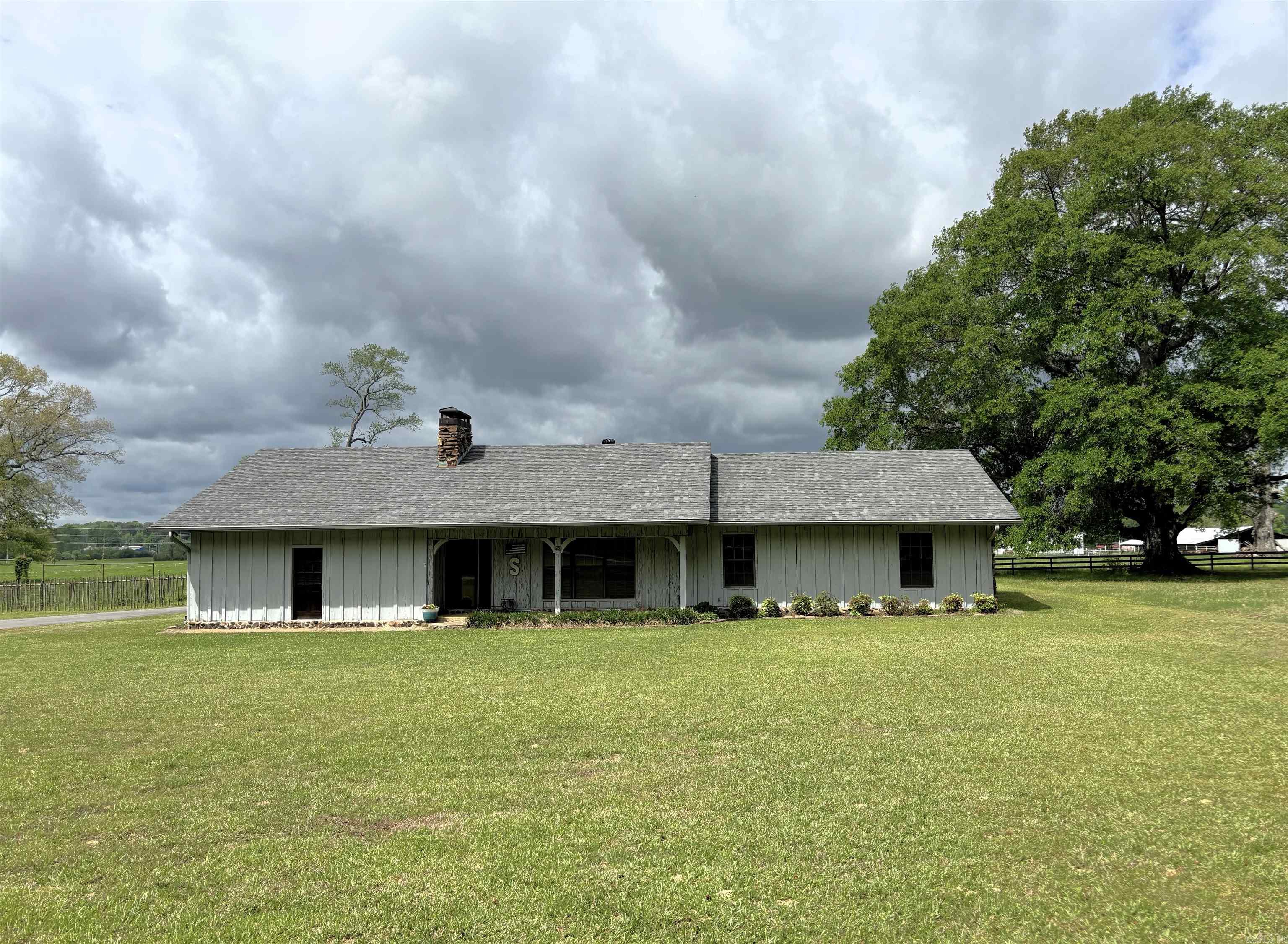 Property Overview Below: Bedrooms/Baths: 3 bedrooms, 2 full baths (flex to convert up to 5 bedrooms) Living Area: Approx. 2,500+ sq ft Location: Edge of town — privacy with quick access to amenities Roofs: House and barn roofs replaced ~1 year ago Interior Highlights: Great Room: Expansive living room with a striking natural rock fireplace Kitchen: Quartz countertops, custom birch cabinetry, abundant workspace Craftsmanship: Heart Cypress wood handpicked by the owner, extensive custom trim Efficiency & Comfort: Extra insulation for sound/privacy and energy performance Flex Spaces: 23' x 22' bonus room plus a separate office—ideal for hobbies, guests, or work-from-home Construction & Structural: Foundation: Extra-wide footings with heavy rebar; walls bolted to slab every few feet for enhanced structural integrity Owner-Built Quality: One-owner home, meticulously maintained Barn: 34' x 30' with an 8' x 30' lean-to Stalls: Four total; two with run-out paddocks. Tack Room: Large, well-organized space This home has an office and huge flex room-perfect for your friends and family.