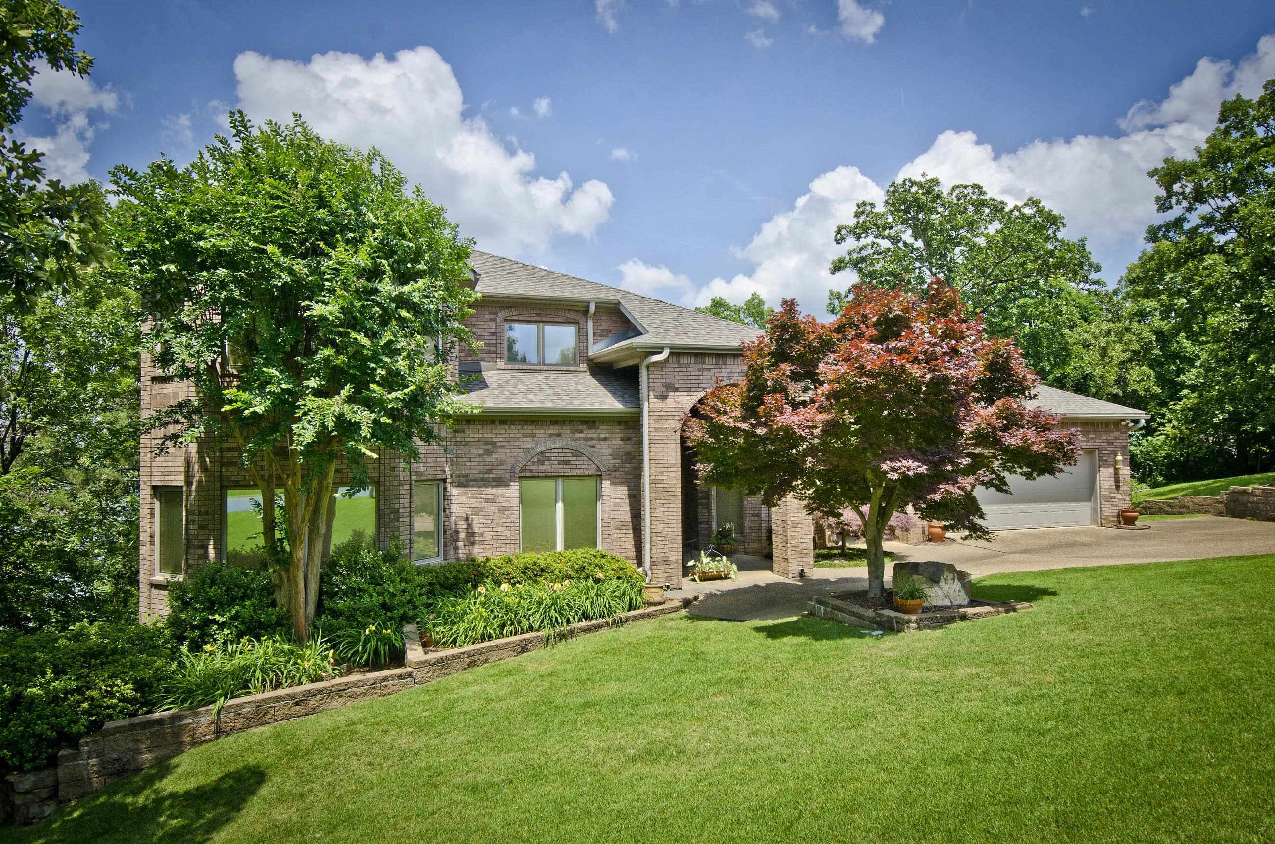 Spectacular Gated Lake Hamilton home located in Stonegate on 126' of frontage. Interior boasts vaulted ceilings & spacious floor plan. Formal dining. Home Library/Office. Open kitchen/living combo w/FP. Breakfast nook w/fantastic lake views. Master en suite w/sitting area & FP, w/wall of custom closet storage & WIC. Lower level has FP & custom bar, Guest quarters & open game room. Three decks make this home perfect for entertaining. Beautifully landscaped flagstone patio. Dock, two covered boat stalls.