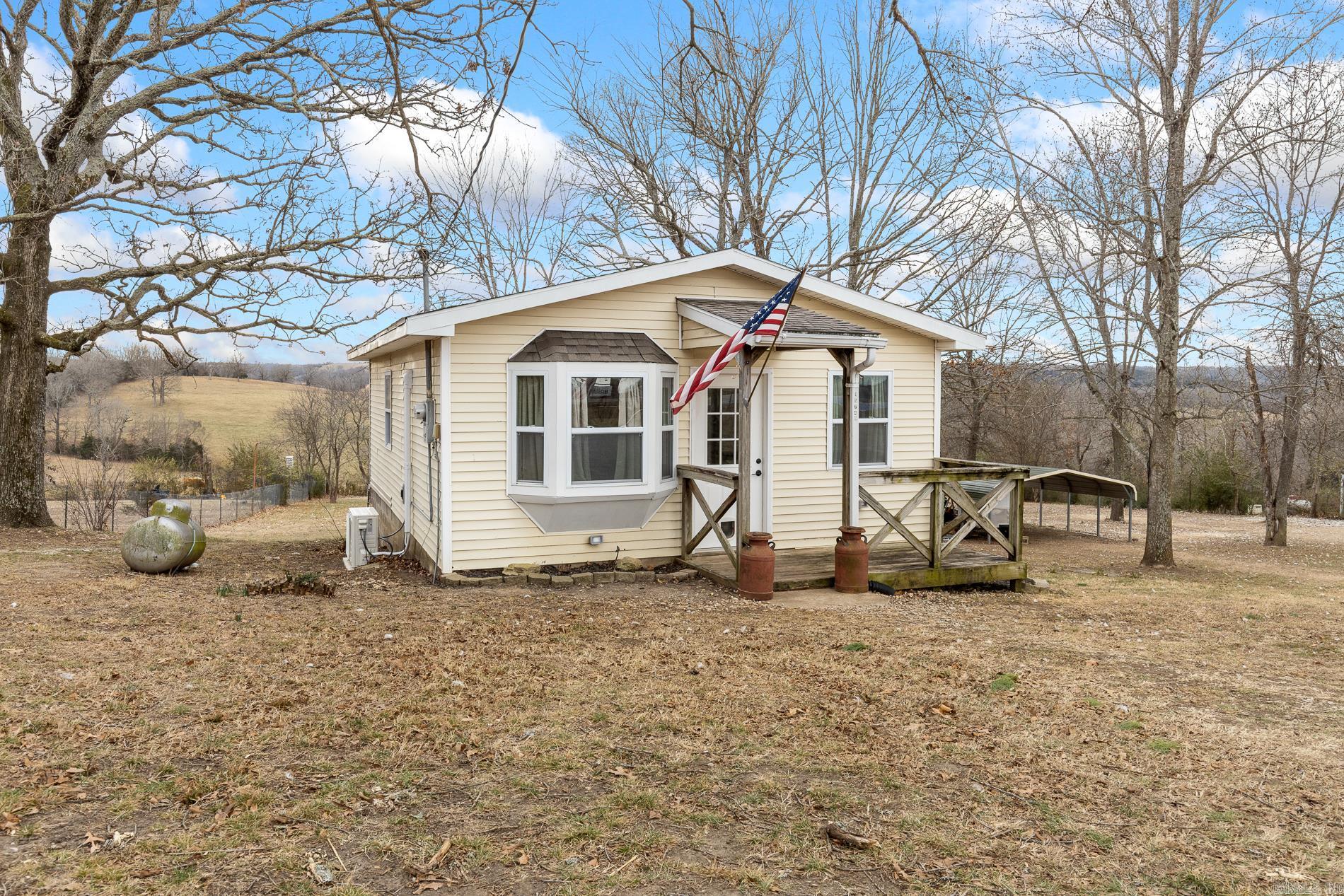 Come take a look at this most impressive, updated tiny home resting on 0.90 m/l acres - perfect for someone wanting a hobby farm, a fishing enthusiast or an investment property owner looking for the perfect nightly rental close to Bull Shoals Lake with easy access to both Diamond City and Peel. The property is mostly fenced, has raised garden beds, a 2 car covered carport (perfect for storing your boat(s) or other toys), storage building and more! The home is so cozy with an open concept living, dining and kitchen space - all recently updated with fresh flooring, paint and appliances. The bedroom and bathroom are large in size and the bedroom features ample storage and a private walk-out covered back deck overlooking your land. This one won't last long!