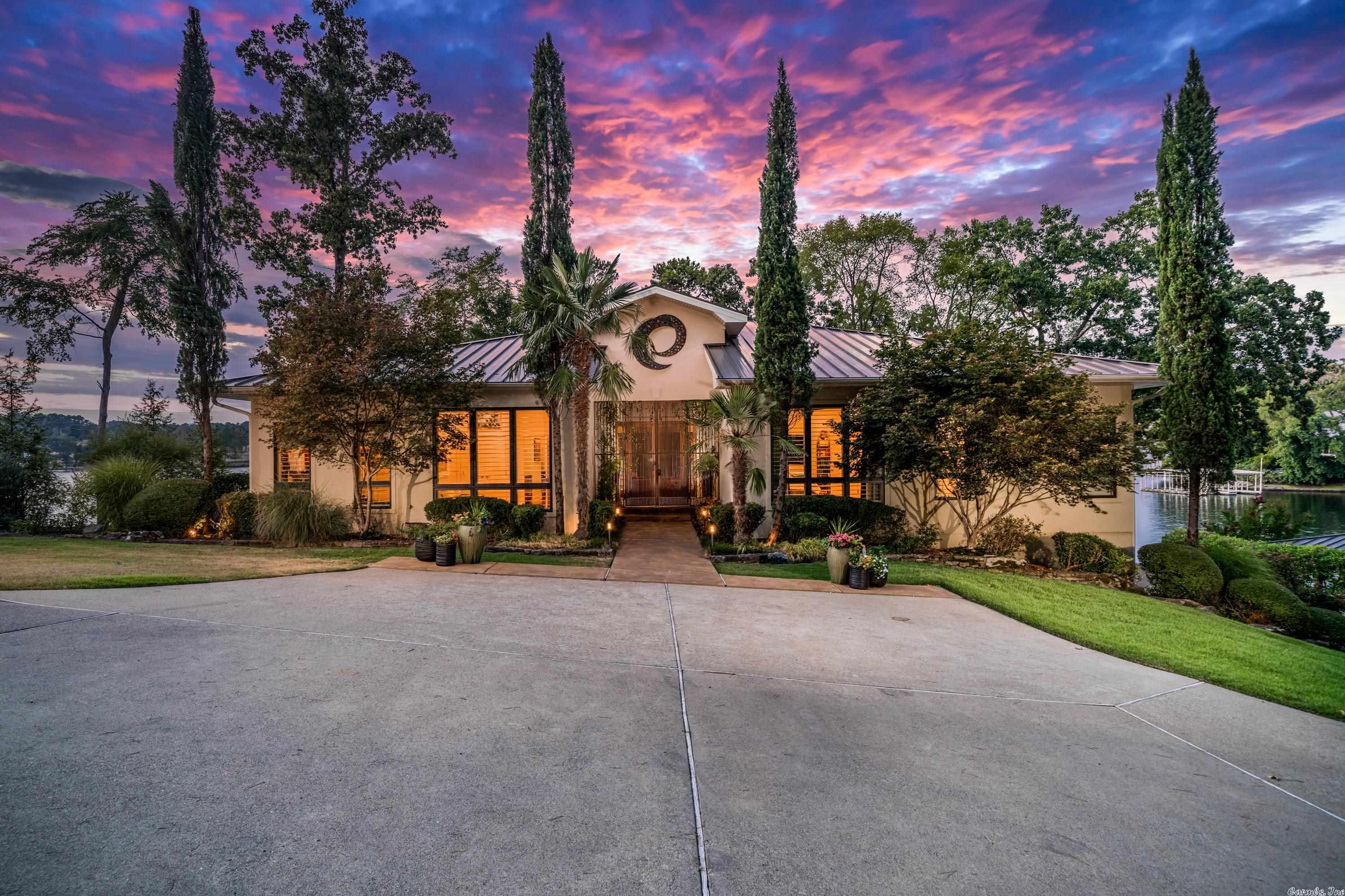 Must see one of the most coveted lake homes on all of Lake Hamilton. This iconic lake front property includes 5 Bedrooms, 5.5Bathrooms, over 5,200 square feet and sits on over 350' of Lake Hamilton. The exterior boast some of the best views on Lake Hamilton,and includes a beautiful gunite pool, outdoor kitchen, and multiple entertaining areas. The interior includes all high end finishes, mainlevel primary with a private terrace, two living areas, large open concept kitchen/dining/living, and much more.
