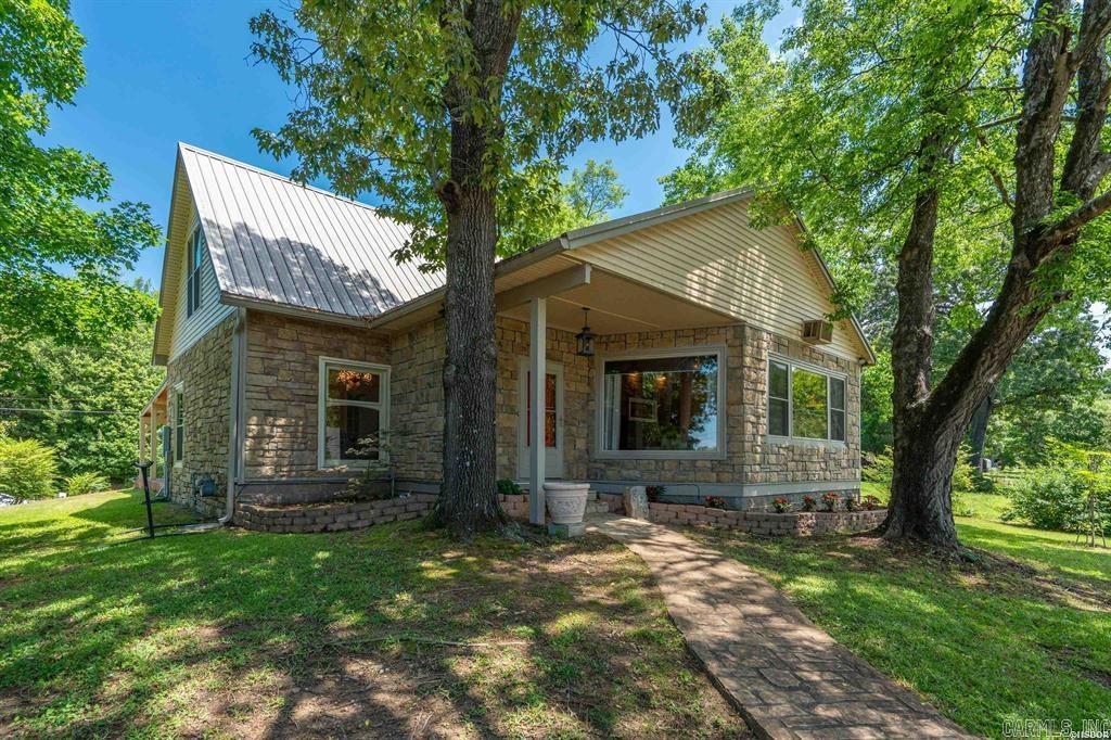 Rare character meets modern peace of mind at 229 Little John Trail, where custom stained glass and epic sunset views take center stage. This FURNISHED 3 bedroom, 2 bathroom home built in 2004 features 1,760 sqft of beautifully updated, move-in-ready living space comes with practically everything. Just bring your toothbrush and move right in.  Location is everything. You are tucked away in a beautiful neighborhood yet conveniently close to major shopping centers, restaurants, top-tier medical facilities, and just a mile from Hot Springs Marina for immediate boat access. The true heart of this home is the inviting living room, perfectly situated to capture beautiful lake views from the front window and epic evening sunsets right from the comfort of your couch. Flowing seamlessly from the living area through the dining room is a gorgeously remodeled kitchen, complete with sleek quartz countertops, modern cabinetry, a premium gas range, and a new under-sink reverse osmosis filtration system. Enjoy the convenience of an expansive driveway with space for multiple cars. Updates include a Brand-New YORK HVAC System (August 2025) and a durable metal roof with new gutters installed in 2023.