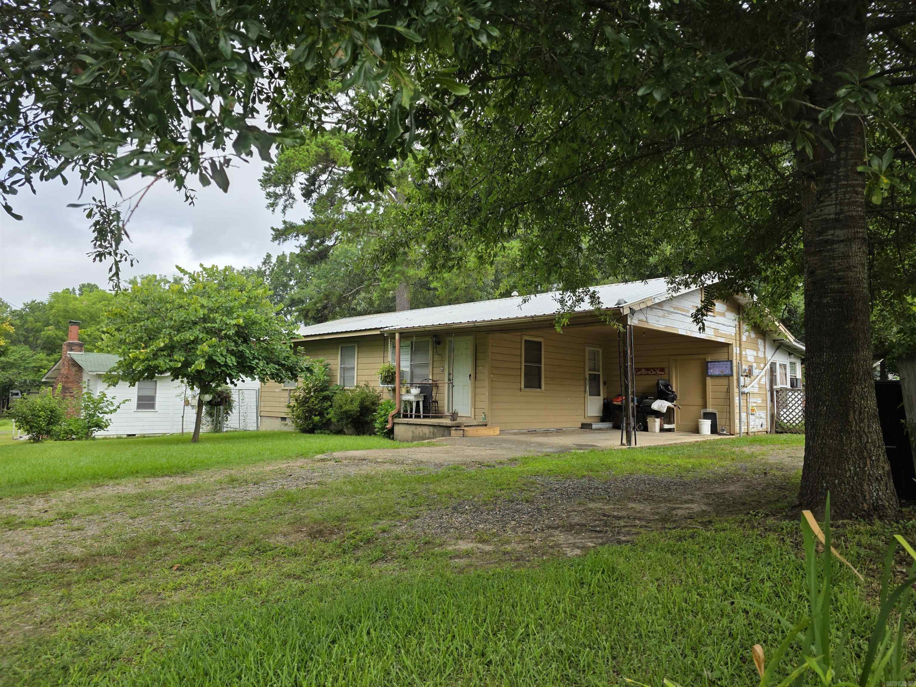 Located in Mena, AR, this 3 bedroom, 2 bath home is a great option for a starter home or investment. The enclosed sunroom is outfitted with a commercial three-bay sink and stainless steel table, perfect for a summer kitchen or hobby space. The property offers two water heaters and two washer/dryer hookups, providing flexible utility options. A workshop/storage area sits just off the back door, plus additional storage at the rear of the home. The shaded yard features blooming flowers and a chicken coop with attached storage. No seller’s disclosure. Conventional or cash financing only. AGENTS: see agent remarks and showing instructions.
