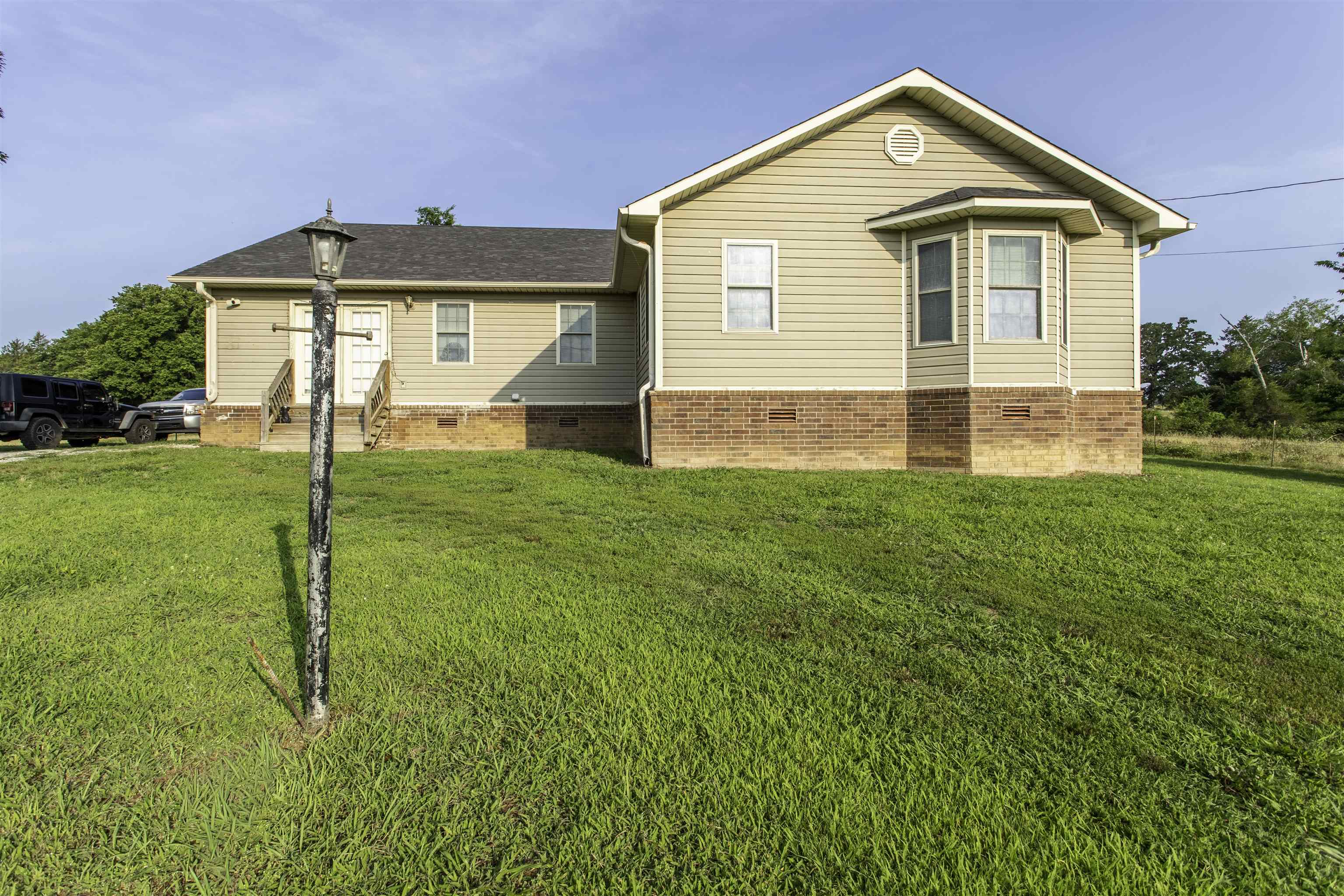 Country Living on 10.45 Acres with Pond, Barn & No Restrictions!  Recently renovated with new drywall, fixtures, lights, and appliances in 2020. Roof and HVAC replaced around 2022.   Escape to the peace and privacy of the Ozarks with this spacious 4-bedroom, 2-bath home situated on 10.45 acres just outside Ravenden. Whether you're looking to start a hobby farm, enjoy a rural lifestyle, or simply have room to roam, this property offers endless possibilities.  The land features a large equipment barn, partially fenced pasture, mature woods, and a pond, creating the perfect setting for livestock, recreation, or simply enjoying nature. Deer frequently travel through the property, making it an excellent location for wildlife enthusiasts and hunters alike.  With no restrictions, you're free to bring your horses, goats, chickens, and other farm animals while creating the country lifestyle you've always envisioned. There's ample space for gardening, additional outbuildings, or expanding your homestead. Tractor negotiable with sale of property. This is one you dont want to miss out on.