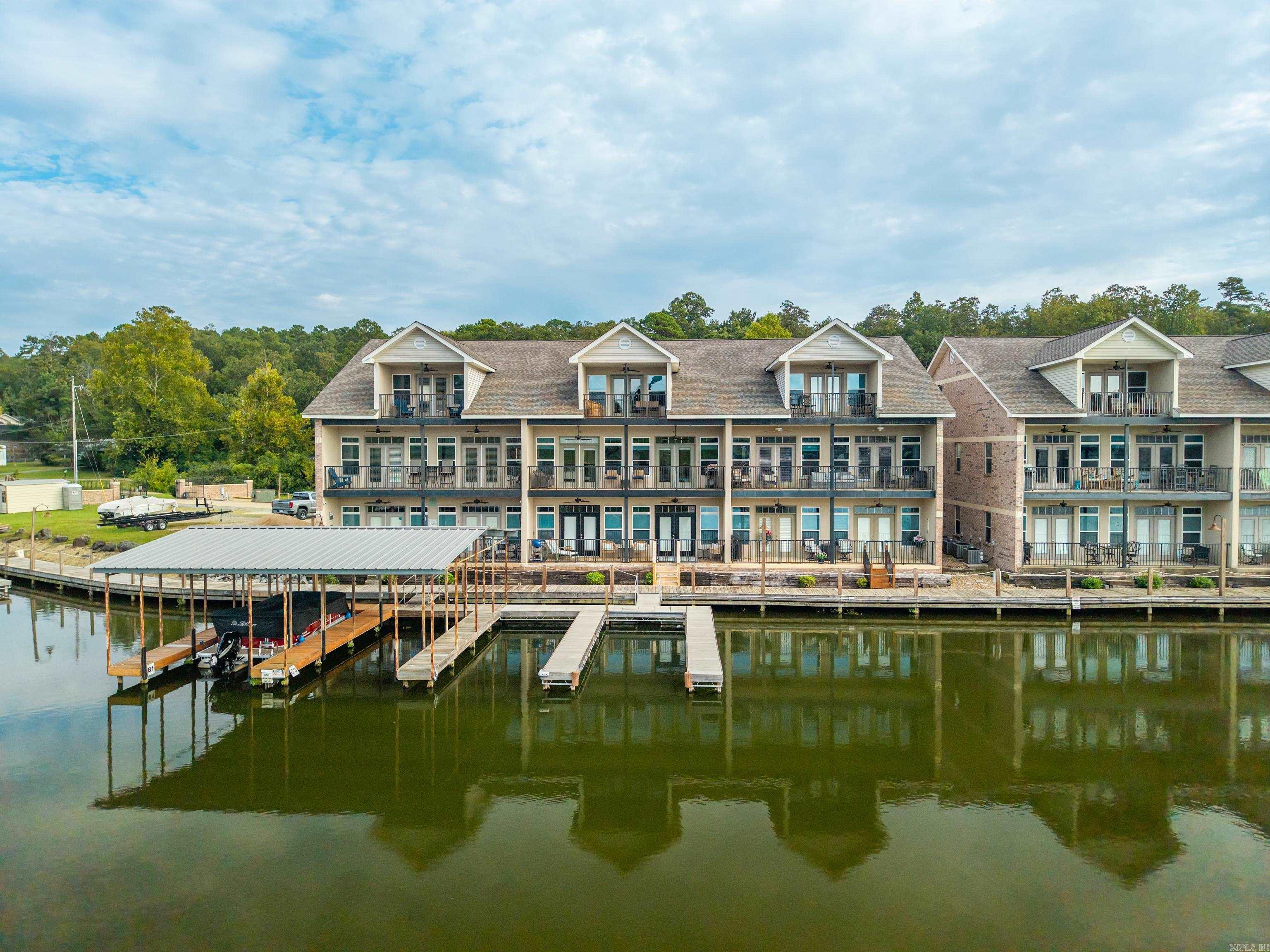 Discover the very best of lake life on Lake Hamilton at 532 Grand Point! An ideal location to all Hot Springs has to offer, you'll be minutes from Oaklawn Racing & Casino Resort, popular restaurants, shopping, hiking trails, historic Bath House Row, healthcare and more. With full water access all four seasons, take advantage of lake activities at your leisure. Enjoy kayaking in the calm, quiet waters just off your patio or fish off your private pier. For convenience and ease, you'll have your own boat slip with a short walk from your door. This two story, three bedroom condo is being offered fully furnished and nightly rentals are allowed. Two spacious bedrooms downstairs with full bathrooms and large closets. One faces the lake with a patio and could suffice as the master. Upstairs you'll find a huge master bedroom with sitting area, private patio overlooking the lake, his and her closets, jetted tub, walk in shower and double vanity sinks with granite countertops. The kitchen/dining area opens up to the living area with a wet bar, and is perfect for entertaining. Granite countertops, stainless appliances, plenty of cabinet/storage space in the kitchen and full size laundry.