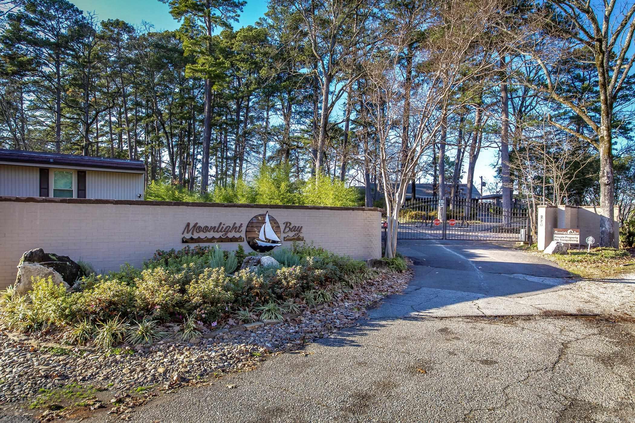 Coveted, gated Moonlight Bay Condominium located on the shores of Lake Hamilton. Experience waterfront living in this beautiful, updated 2 bedroom, 2.5 bath condo and enjoy the breathtaking, panoramic lakefront views from the den, covered patio and master bedroom. Updates include custom window treatments, quartz counters, lighting, and white oak floors, new dishwasher, new hot water heater, replaced front window. There are two large outside storage rooms on the patio. This convenient location in the heart of Lake Hamilton is just minutes away from downtown Hot Springs, Oaklawn, restaurants, shopping and entertainment venues for the entire family.  This a perfect blend of lake living and enjoying what Hot Springs has to offer.  Private boat ramp located on property.  No nightly rentals. See Agent Remarks.