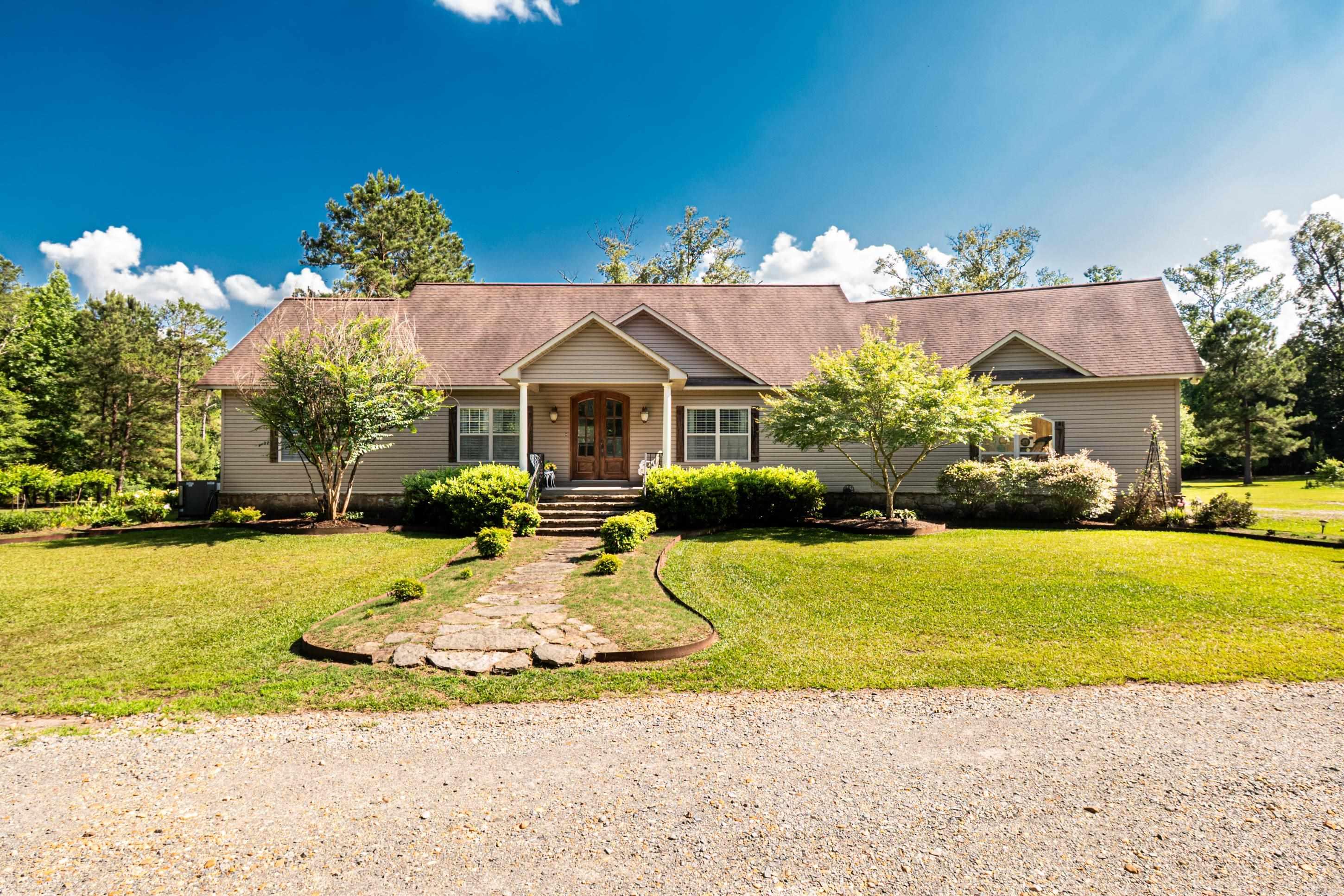 Welcome to 1675 O’Rear Road, a well-built 2,426 SF home offering 3 bedrooms, 2.5 baths, plus a spacious bonus room that could serve as a fourth bedroom, office, playroom, or guest space. The kitchen features custom cabinetry, and the primary suite includes a walk-in shower and private access to the covered porch. A wood-burning fireplace accented with Arkansas natural stone adds warmth and character, with coordinating stone details on the exterior. Extra insulation helps support energy efficiency and lower utility costs.  Thoughtfully positioned on 23.66 acres, the home sits near the property’s fruit trees, stocked pond, garden, chicken coop, pasture, and animal areas. The pond is stocked with bream, crappie, and bass, while mature pine and hardwood trees and winding trails create a peaceful setting for walking, riding, or exploring. A small pasture offers space for a horse or a few cows. Private, practical, and full of possibilities, this property offers a lifestyle that is increasingly hard to find.