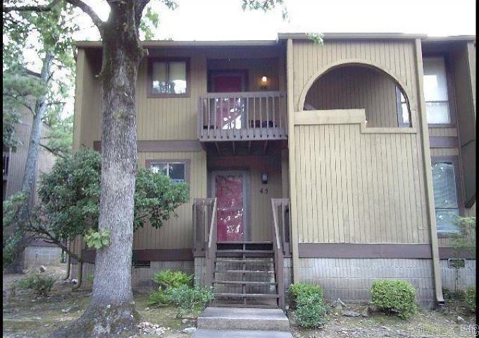 First Floor Condo with new HVAC and paint!!! Updated 2 bedroom 2 bathroom.  Large living/dining room has a wood burning fireplace with glass doors. Newer countertops in kitchen plus refrigerator. Beautiful wood floors, too!! Newer granite countertops in kitchen, pullout shelves for cans, plus refrigerator conveys.  Updated primary bedroom with space for a small desk.  Bath has updated countertops and wonderful walk-in shower. Large private balcony overlooking the pool. Exterior storage closet. Designated parking plus visitor.