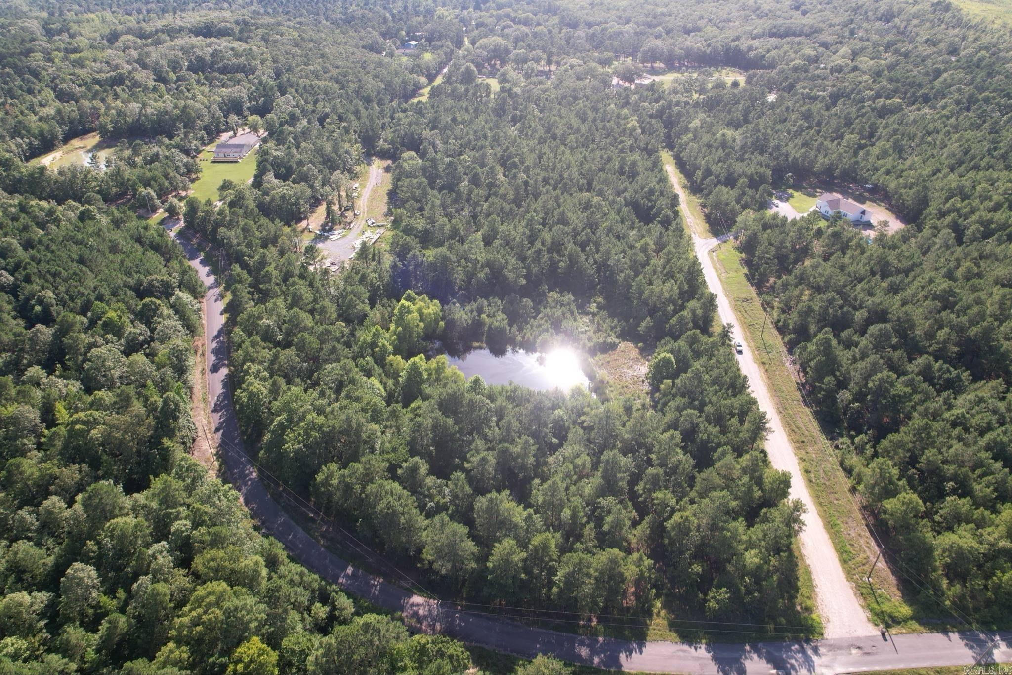 Gorgeous 11.41 acre property located off of Hwy 298 with the option of multiple building sites.  Level land with pond, utility access at the street or at a half way point in land.  Some livestock allowed.  Remote but easy access to Lake Quachita. Excellent land and location for your Dream home in the Jessieville School District.