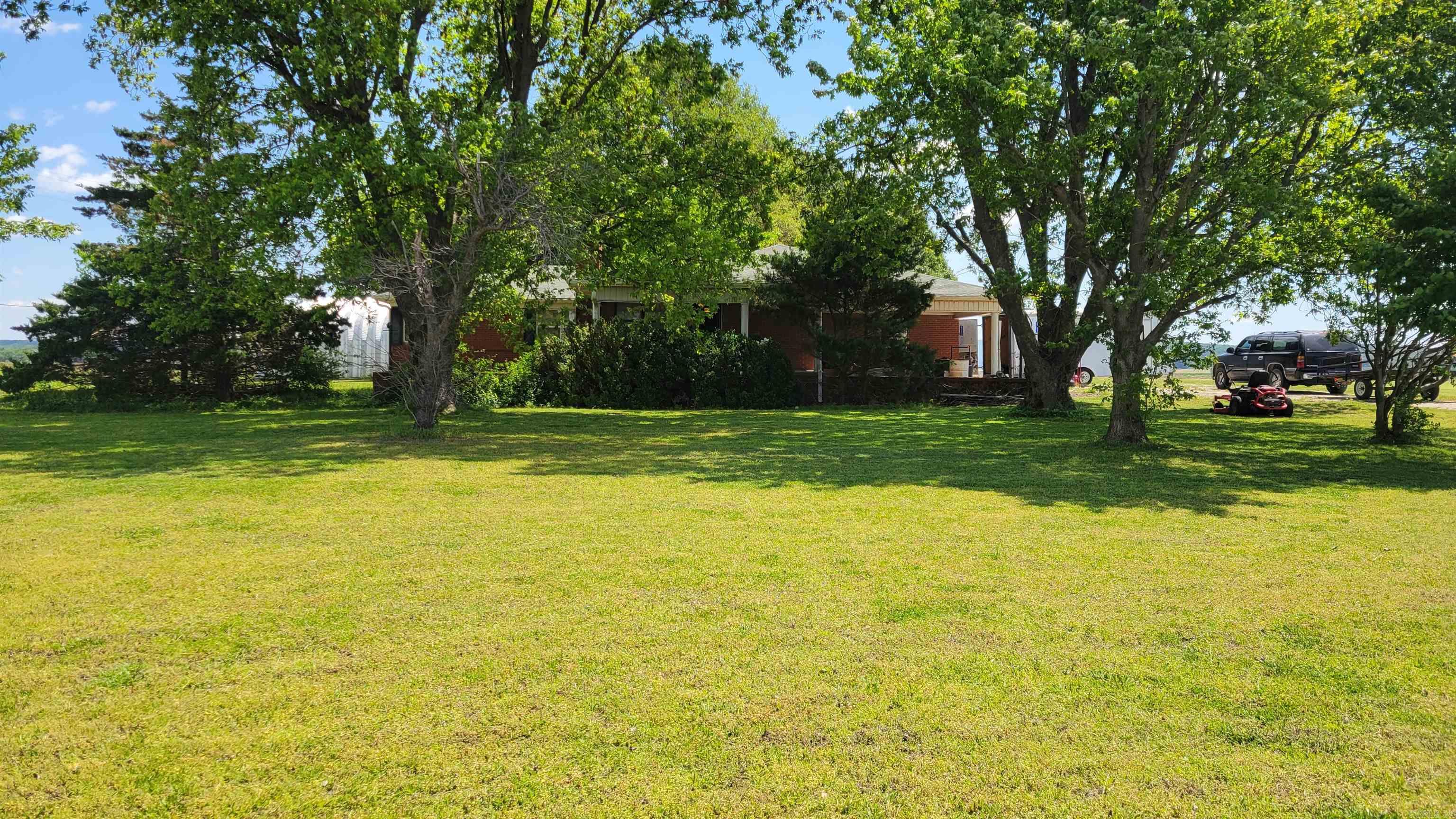 Charming brick home with solid bones situated on 1.06 acres of level, open land offering endless possibilities. This well-built property features a cozy wood-burning fireplace in the large living room. The outdoor space is perfect for gardening, recreation, or future improvements, and gives the peaceful feel of country living. With a strong structure and timeless brick exterior, this home is ready for your personal touch to make it truly your own.