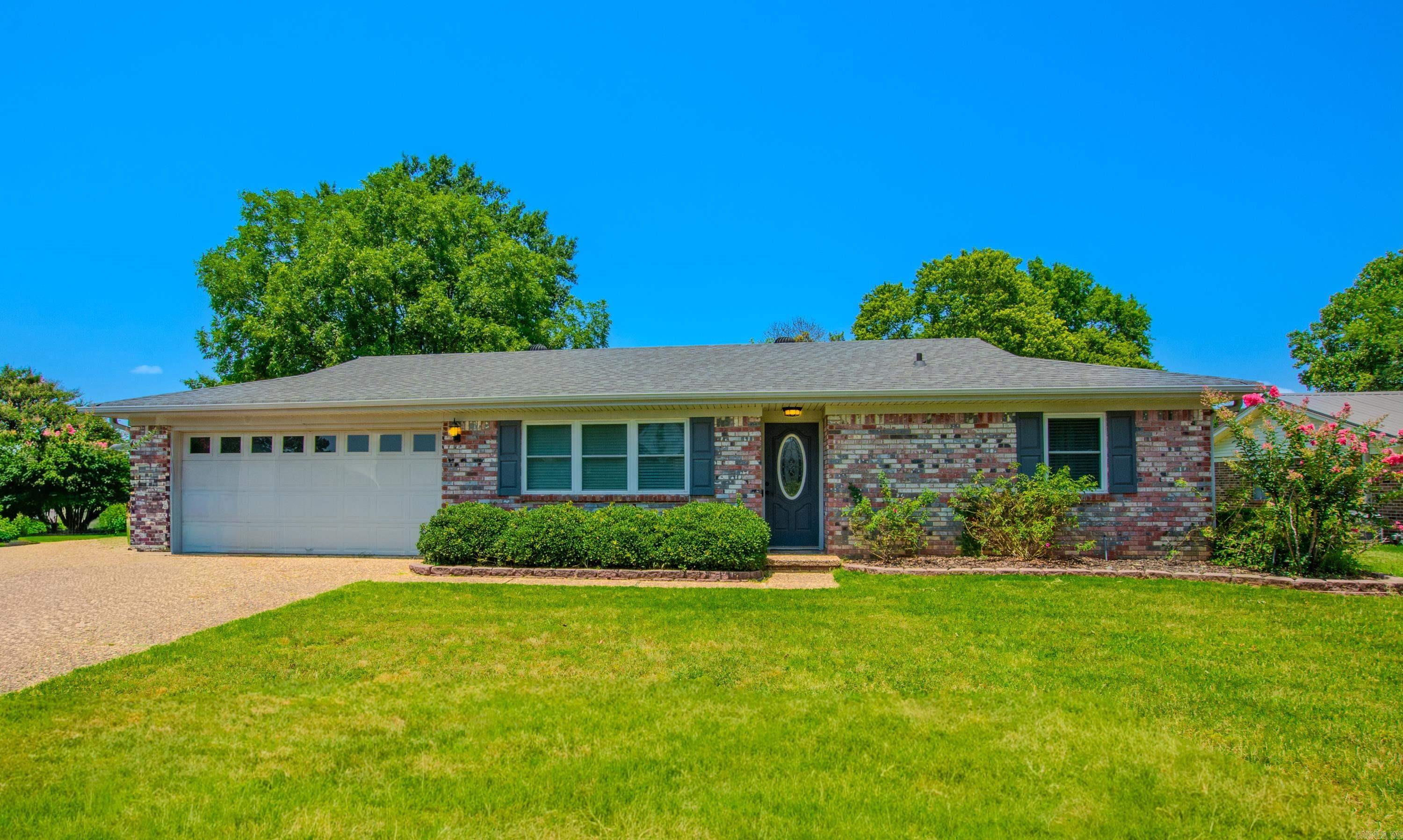 Welcome home to this beautiful all-brick home situated on a desirable corner lot in the Stonewall subdivision. The spacious den features stunning Brazilian cherry hardwood floors and a gorgeous stone corner fireplace with gas logs. The eat-in kitchen offers beautiful white cabinetry and plenty of space for everyday dining. The large primary suite includes two closets and an updated en-suite bath. French doors open to a private backyard oasis complete with a large wood deck, additional patio, and fully wood-fenced yard—perfect for entertaining, relaxing, or enjoying outdoor living. This move-in-ready home combines comfort, charm, and functionality in an established neighborhood. Schedule your showing today! sqft approx. swing set in the backyard does not stay.
