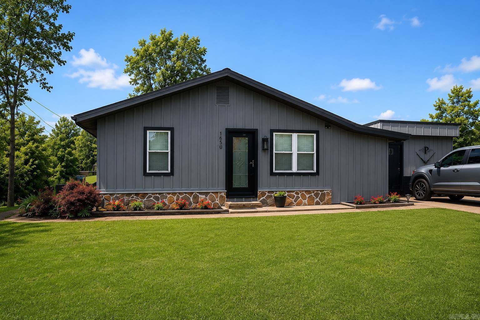 Listed at $178,900, this beautifully maintained 2-bedroom, 2-bath home offers 1,167 square feet of comfortable living space in the desirable Telico Trails community. Enjoy your own private outdoor oasis with a spacious deck overlooking the lake, providing the perfect place to relax, entertain guests, or enjoy your morning coffee while taking in the peaceful views.  Inside, the home features a renovated primary suite, laminate flooring throughout, and tile flooring in the hall bathroom. The beautifully landscaped yard enhances the property’s charm and curb appeal, while the lake views create a serene setting you’ll love coming home to. An added bonus is the shop with electricity, offering excellent space for hobbies, storage, or a workshop.  Whether you’re a first-time homebuyer, looking to downsize, or simply searching for a peaceful lakeside retreat, this property has so much to offer. Showings are by appointment only. To schedule your private tour, contact Chandle Rice at 870-270-2201.